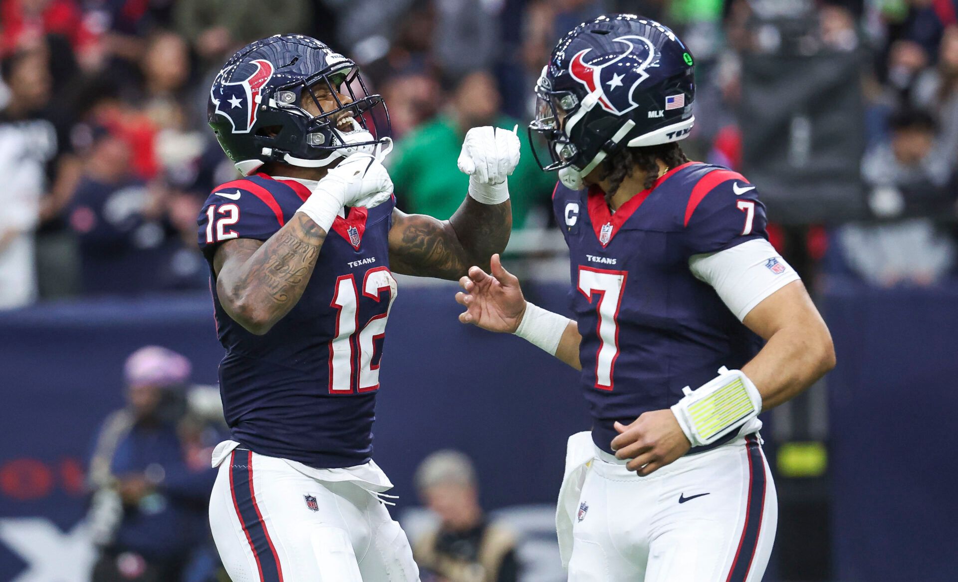 Jan 13, 2024; Houston, Texas, USA; Houston Texans wide receiver Nico Collins (12) celebrates with quarterback C.J. Stroud (7) after a touchdown in a 2024 AFC wild card game against the Cleveland Browns at NRG Stadium. Mandatory Credit: Troy Taormina-USA TODAY Sports