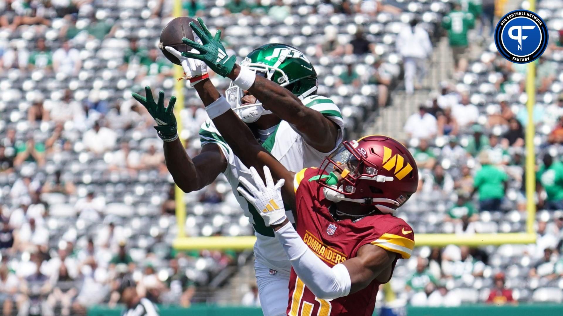 Aug 10, 2024; East Rutherford, New Jersey, USA; Washington Commanders cornerback Emmanuel Forbes (13) breaks up a pass to New York Jets wide receiver Mike Williams (18) during the first quarter at MetLife Stadium. Mandatory Credit: Lucas Boland-USA TODAY Sports