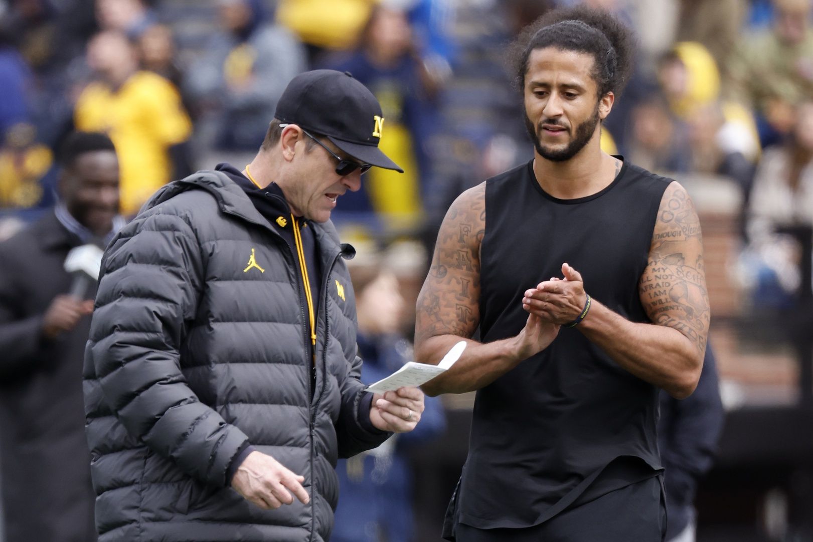 Michigan Wolverines head coach Jim Harbaugh talks to Colin Kaepernick during halftime at the Michigan Spring game at Michigan Stadium. Mandatory Credit: Rick Osentoski-USA TODAY Sports