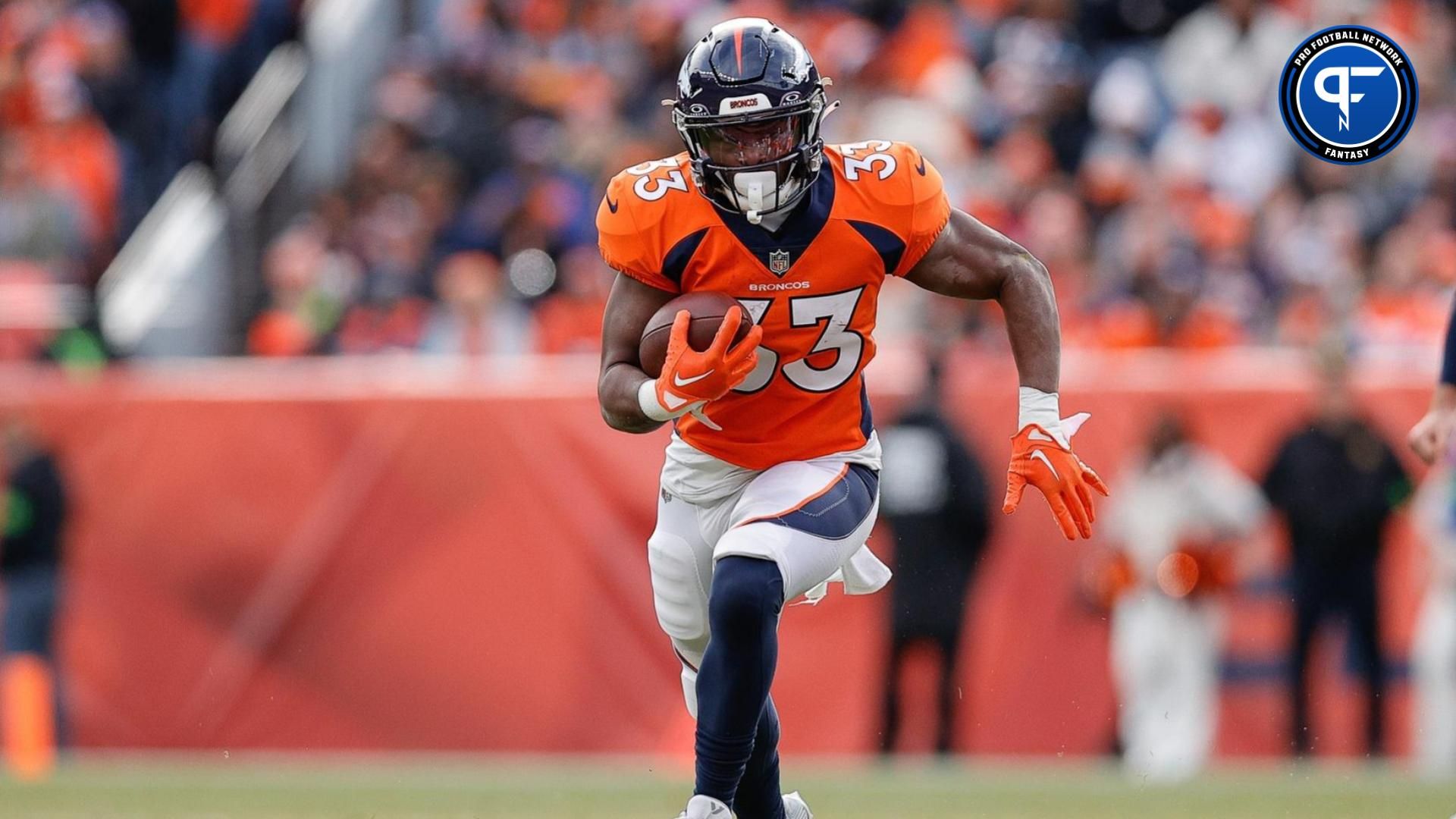 Denver Broncos running back Javonte Williams (33) runs the ball in the first quarter against the Los Angeles Chargers at Empower Field at Mile High. Mandatory Credit: Isaiah J. Downing-USA TODAY Sports