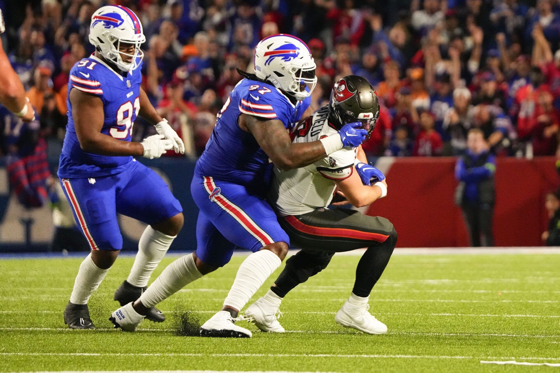 Former Buffalo Bills and current Dallas Cowboys defensive tackle Jordan Phillips (97) commits a facemark penalty while tackling Tampa Bay Buccaneers quarterback Baker Mayfield (6) during the second half at Highmark Stadium.