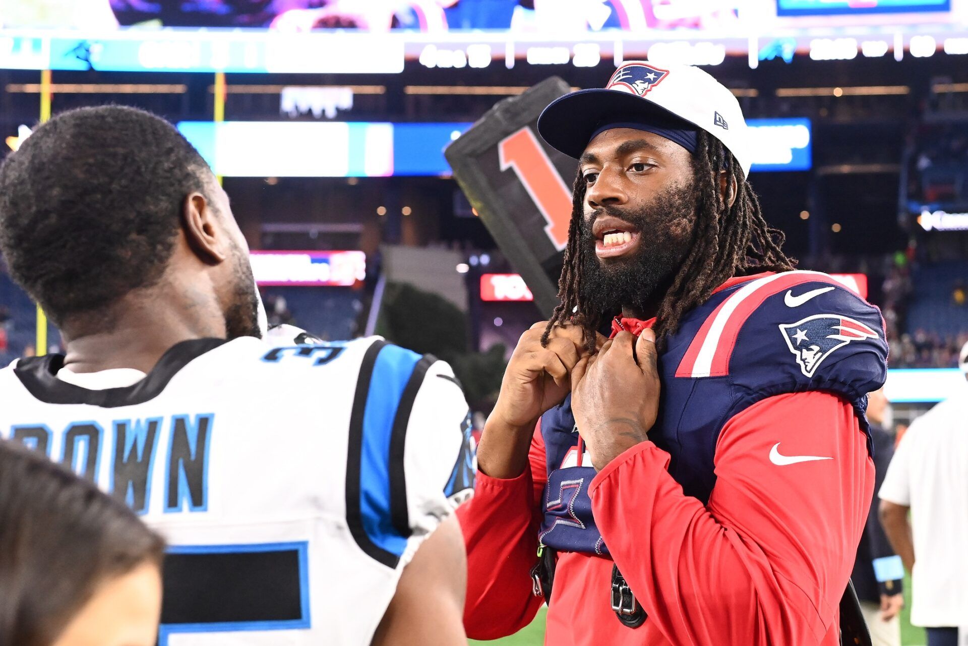 New England Patriots LB Matthew Judon (9) talks to Carolina Panthers CB Anthony Brown (35) after the game.