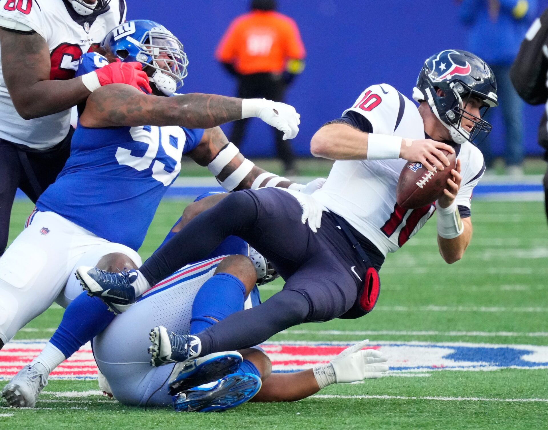 New York Giants defensive tackle Dexter Lawrence (97) sacks Houston Texans quarterback Davis Mills (10) during the third quarter of a game at MetLife Stadium.