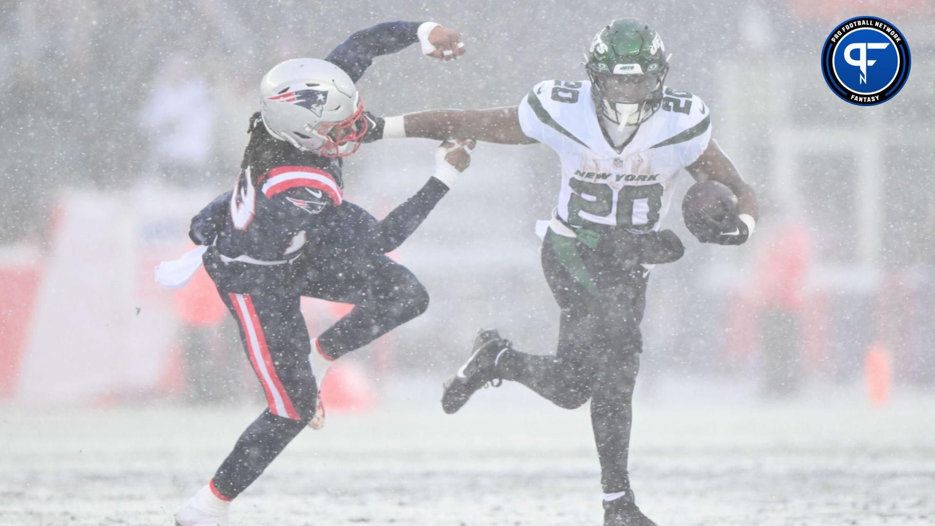 New York Jets running back Breece Hall (20) breaks a tackle from New England Patriots safety Kyle Dugger (23) during the first half at Gillette Stadium.