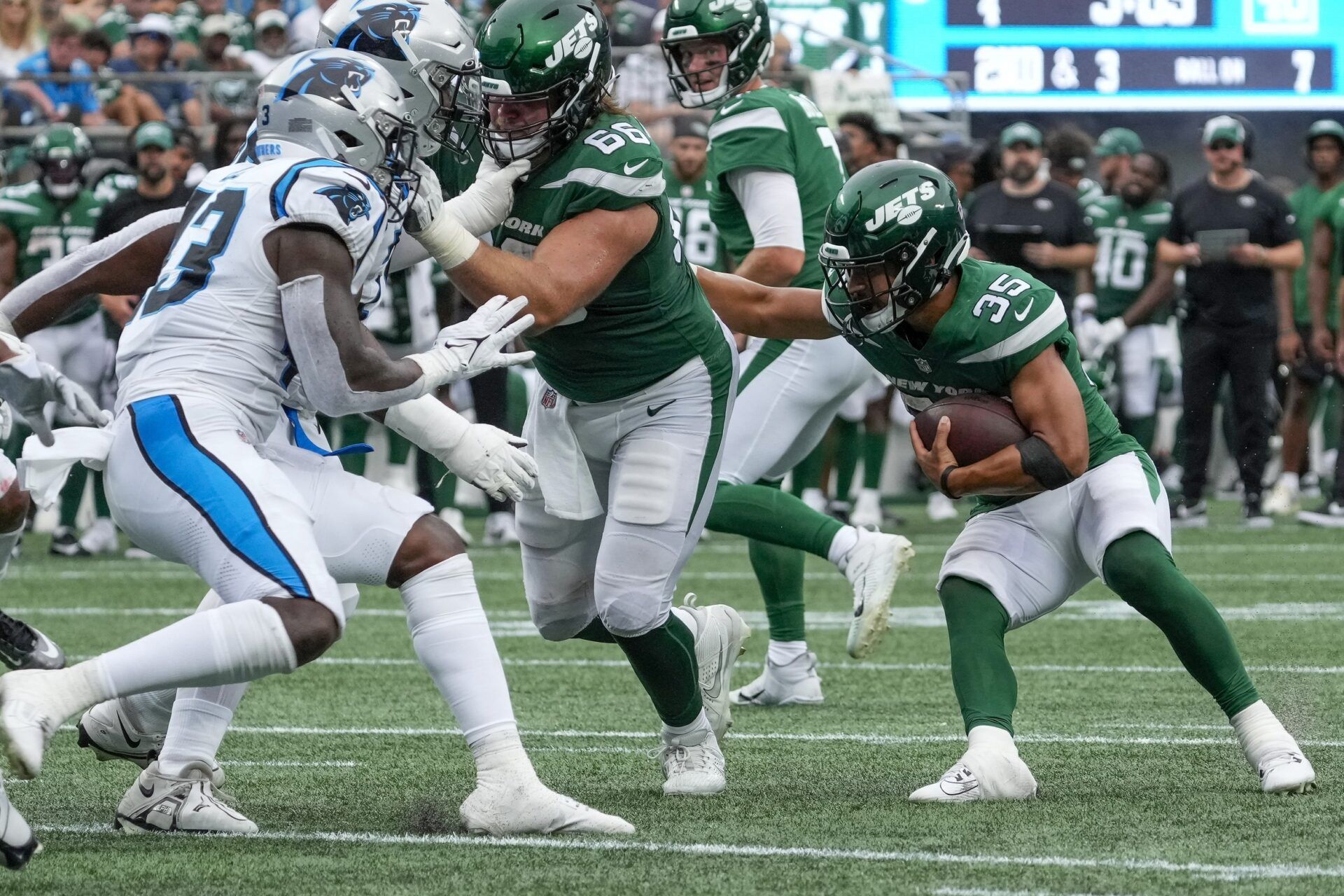 New York Jets running back Travis Dye (35) follows the block by center Joe Tippmann (66) during the second half against the Carolina Panthers at Bank of America Stadium. Mandatory Credit: Jim Dedmon-USA TODAY Sports