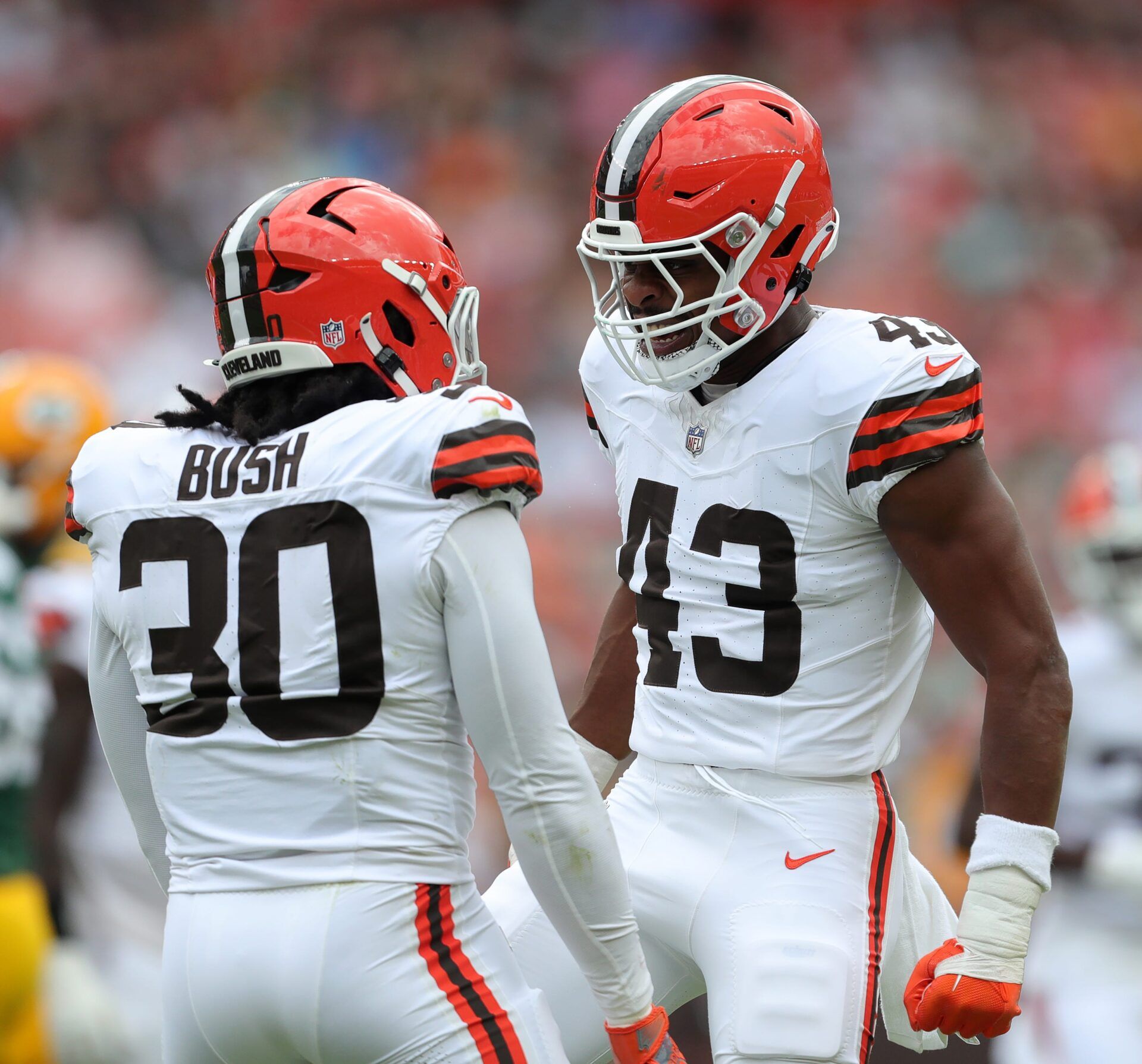 Cleveland Browns linebacker Devin Bush (30) and Cleveland Browns linebacker Mohamoud Diabate (43) celebrate a stop against the Green Bay Packers during the first half of an NFL preseason football game at Cleveland Browns Stadium, Saturday, Aug. 10, 2024, in Cleveland, Ohio. © Jeff Lange / USA TODAY NETWORK