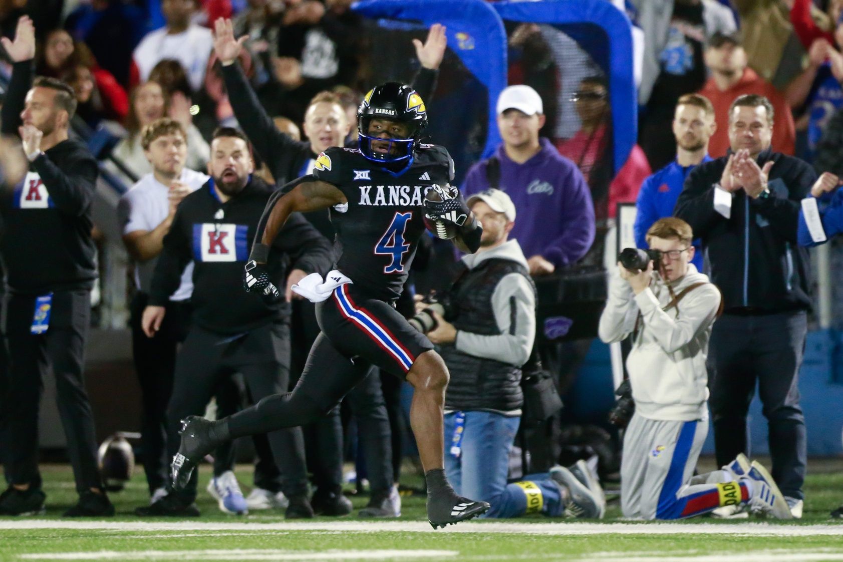 Kansas junior running back Devin Neal (4) runs in for a touchdown in the first quarter of Saturday's Sunflower Showdown against Kansas State inside David Booth Kansas Memorial Stadium.