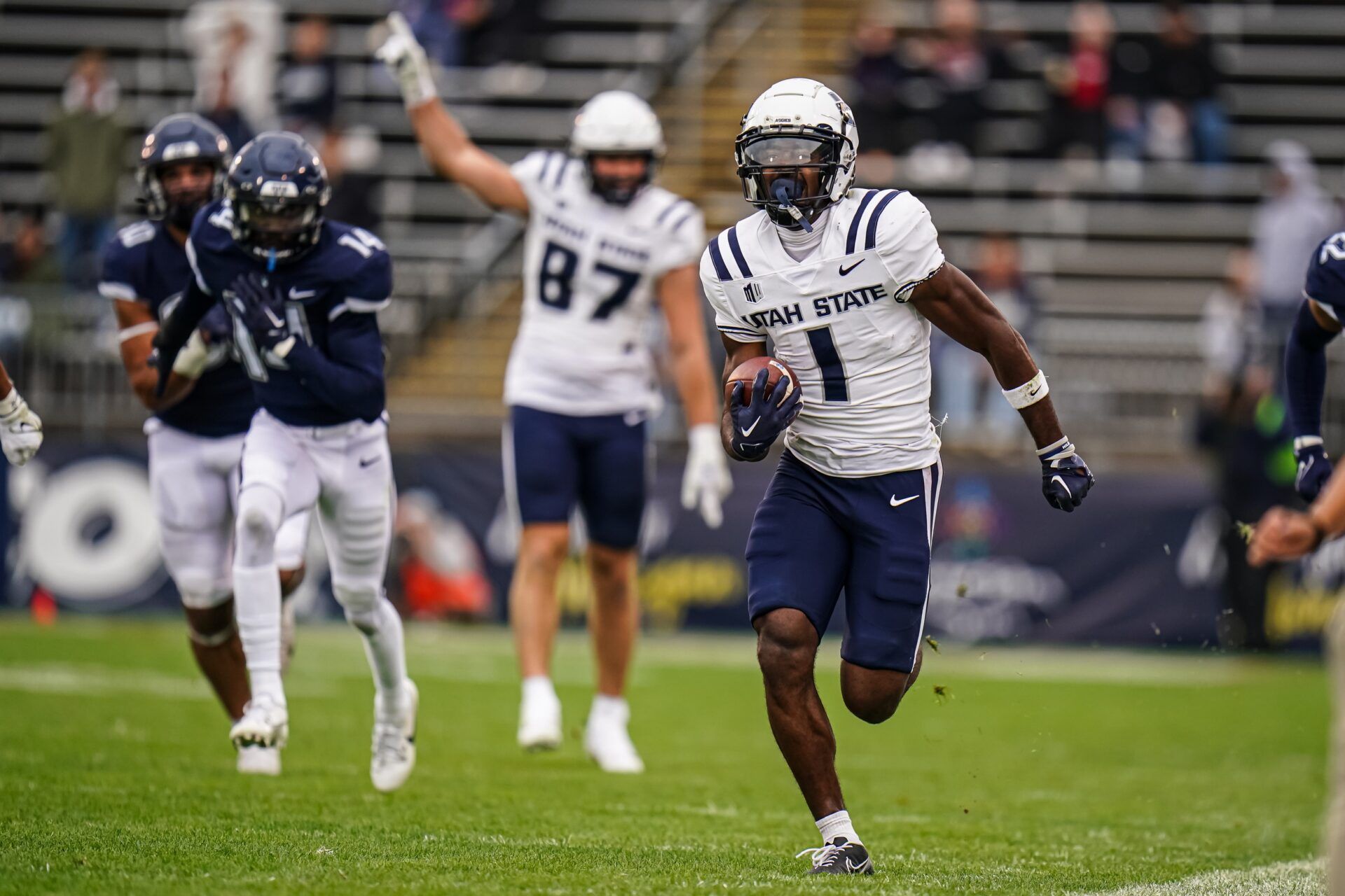 Utah State Aggies wide receiver Jalen Royals (1) runs the ball for a touchdown against the UConn Huskies in the second half at Rentschler Field at Pratt & Whitney Stadium. Mandatory Credit: David Butler II-USA TODAY Sports