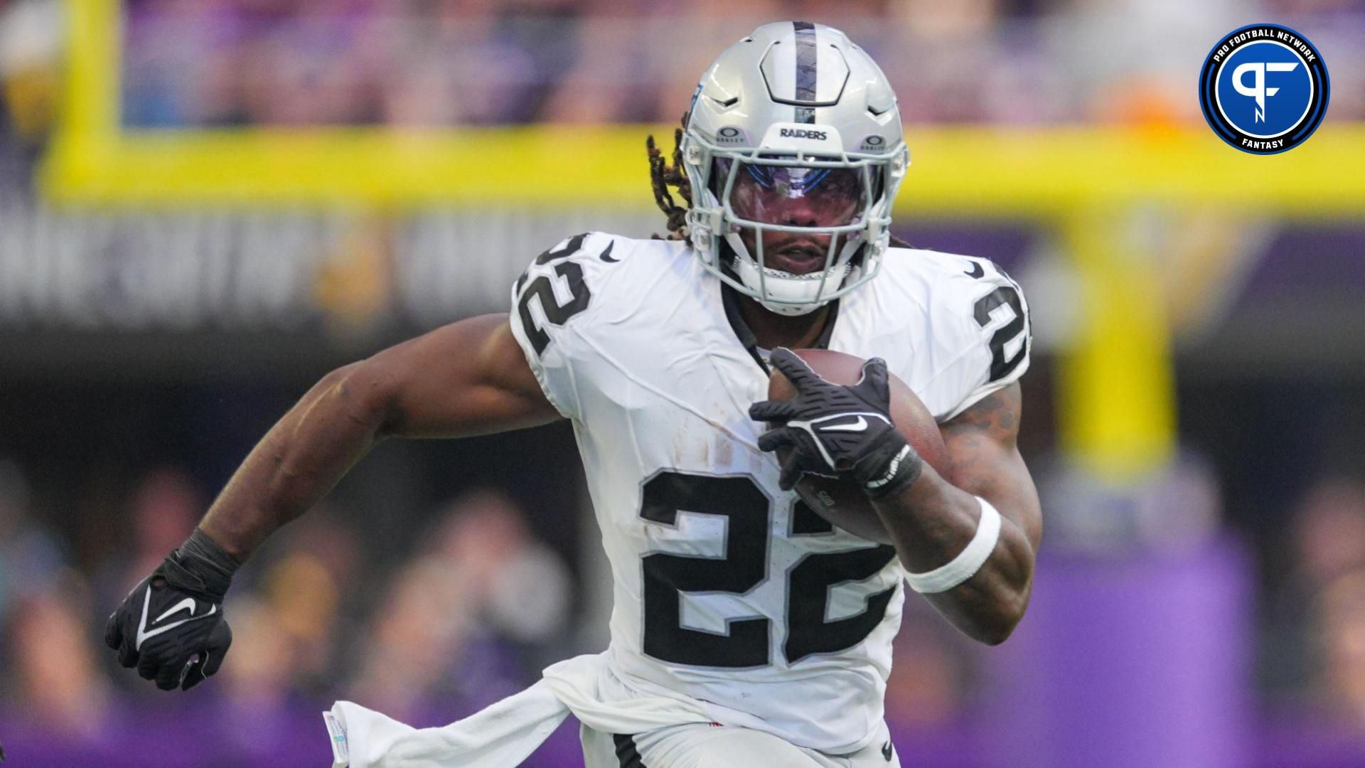 Las Vegas Raiders running back Alexander Mattison (22) runs with the ball against the Minnesota Vikings in the second quarter at U.S. Bank Stadium. Mandatory Credit: Brad Rempel-USA TODAY Sports