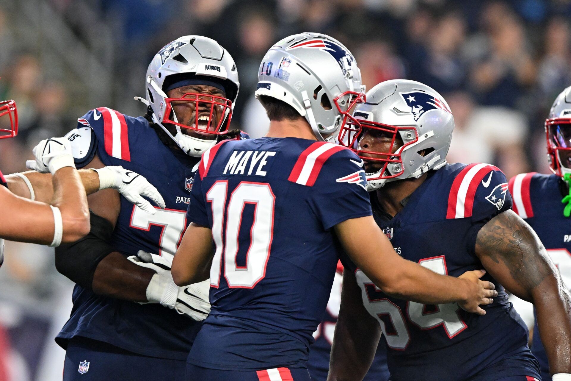 New England Patriots quarterback Drake Maye (10) celebrates with offensive tackle Caedan Wallace (70) and guard Layden Robinson (64) after scoring a touchdown against the Philadelphia Eagles during the first half at Gillette Stadium. Mandatory Credit: Brian Fluharty-USA TODAY Sports