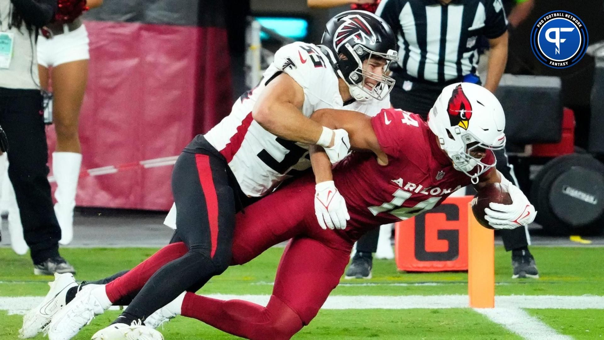 Arizona Cardinals wide receiver Michael Wilson (14) is down short of the goal line against Atlanta Falcons linebacker Kaden Elliss (55) in the second half at State Farm Stadium.