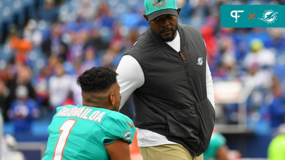 Former Miami Dolphins head coach Brian Flores talks to QB Tua Tagovailoa (1).