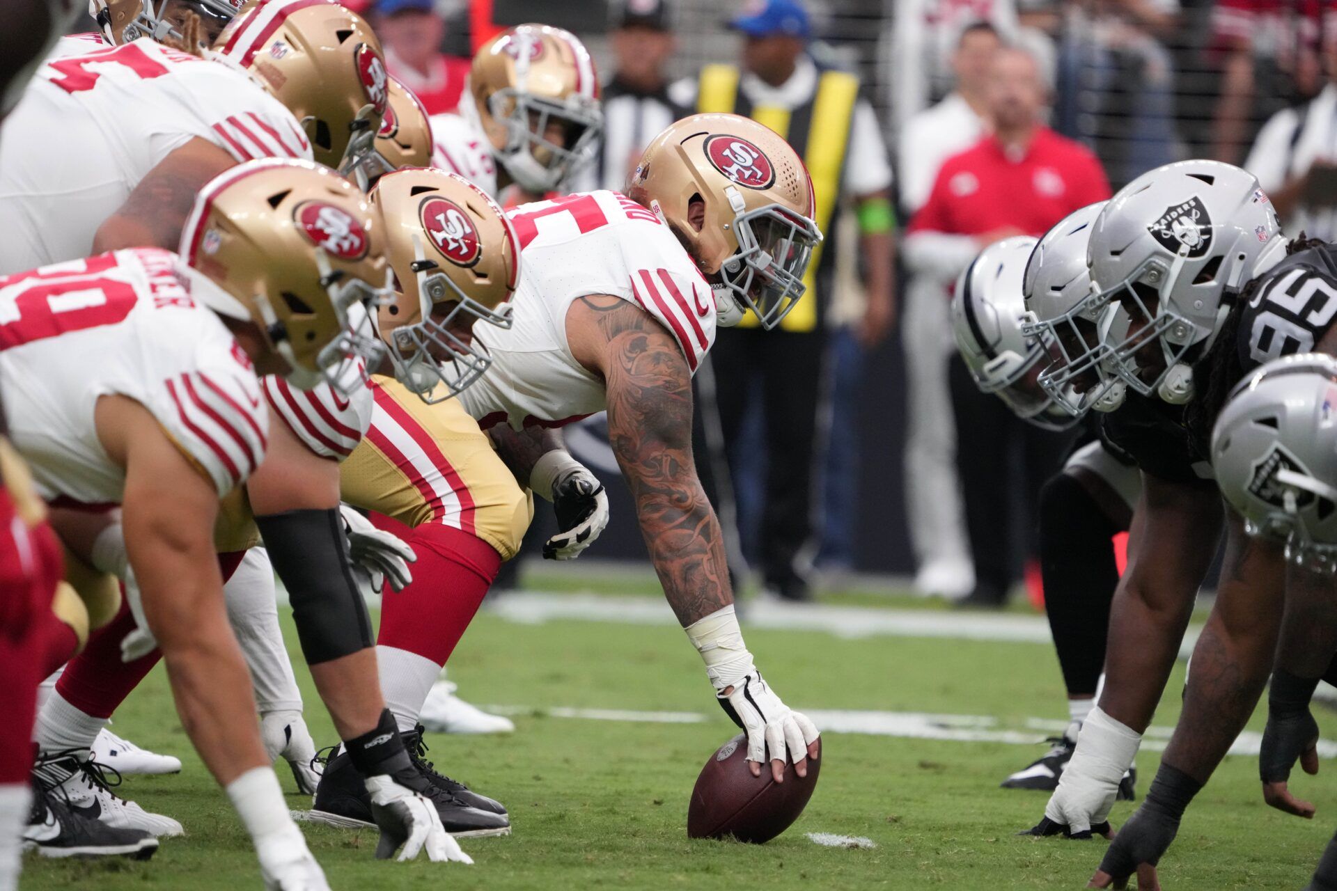 A general overall view of helmets at the line of scrimmage as San Francisco 49ers guard Jon Feliciano (55) snaps the ball against the Las Vegas Raiders in the first half at Allegiant Stadium. Mandatory Credit: Kirby Lee-USA TODAY Sports