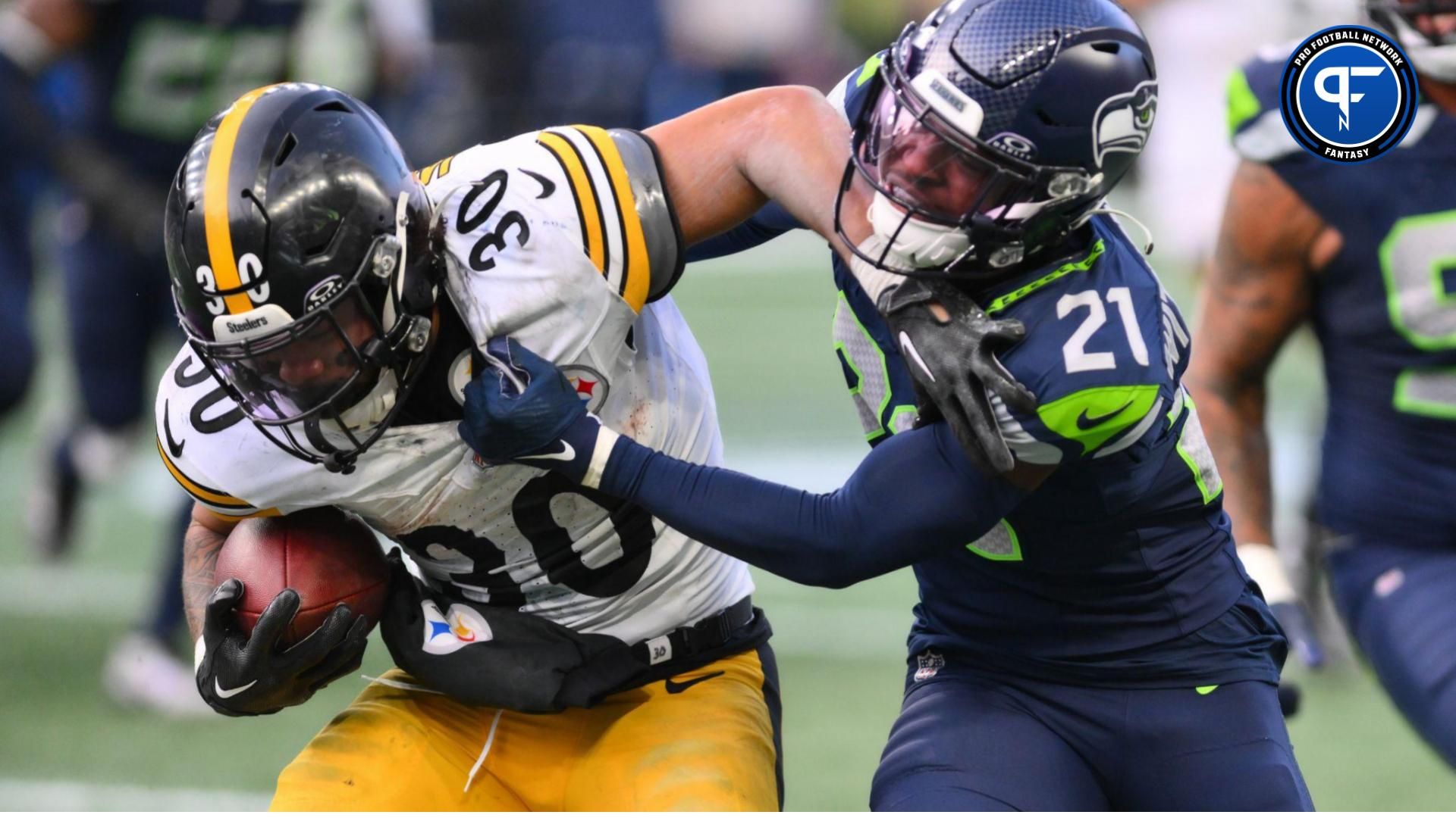 Seattle Seahawks cornerback Devon Witherspoon (21) tackles Pittsburgh Steelers running back Jaylen Warren (30) during the second half at Lumen Field. Warren is a headliner on our Fantasy football injury report. Mandatory Credit: Steven Bisig-USA TODAY Sports