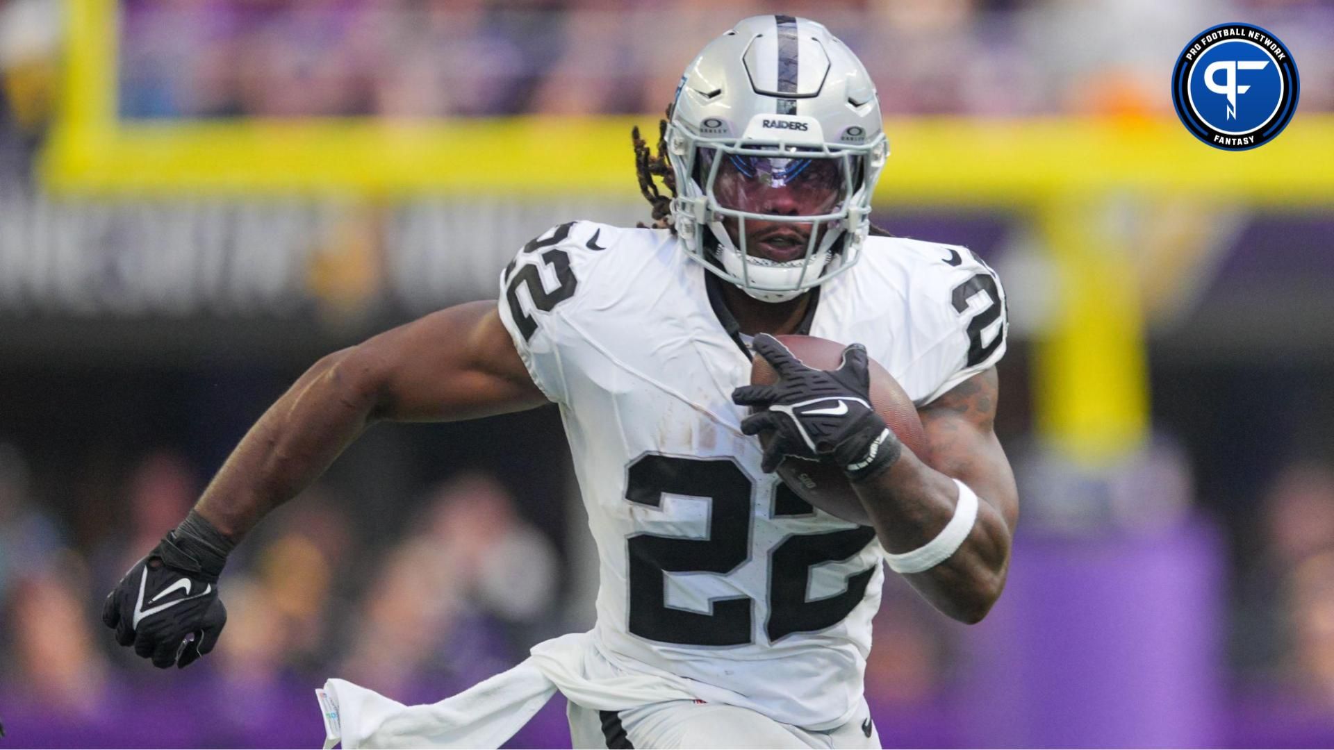 Las Vegas Raiders running back Alexander Mattison (22) runs with the ball against the Minnesota Vikings in the second quarter at U.S. Bank Stadium. Mandatory Credit: Brad Rempel-USA TODAY Sports