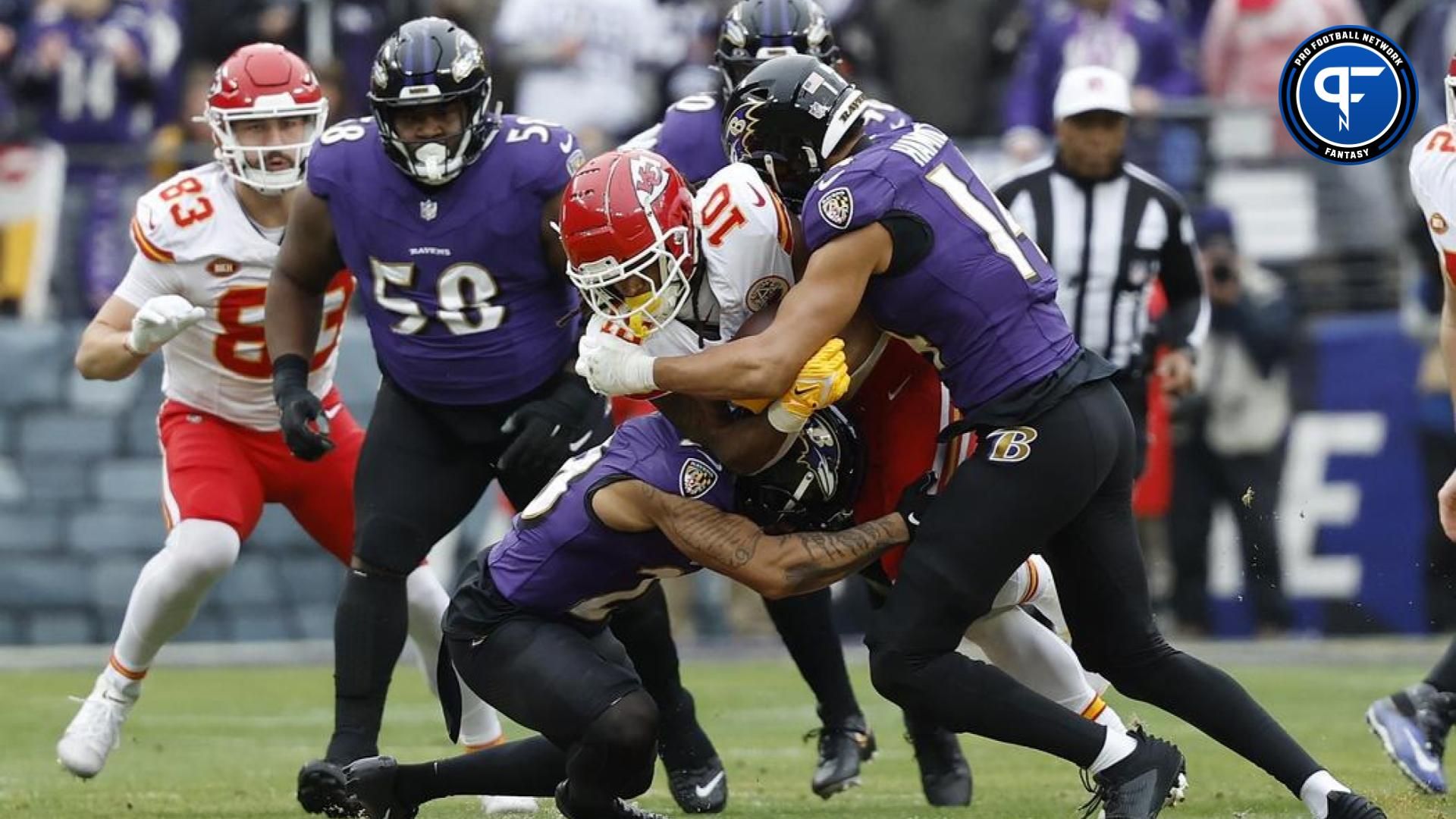 Kansas City Chiefs running back Isiah Pacheco (10) carries the ball as Baltimore Ravens safety Kyle Hamilton (14) defends during the first half in the AFC Championship football game at M&T Bank Stadium.