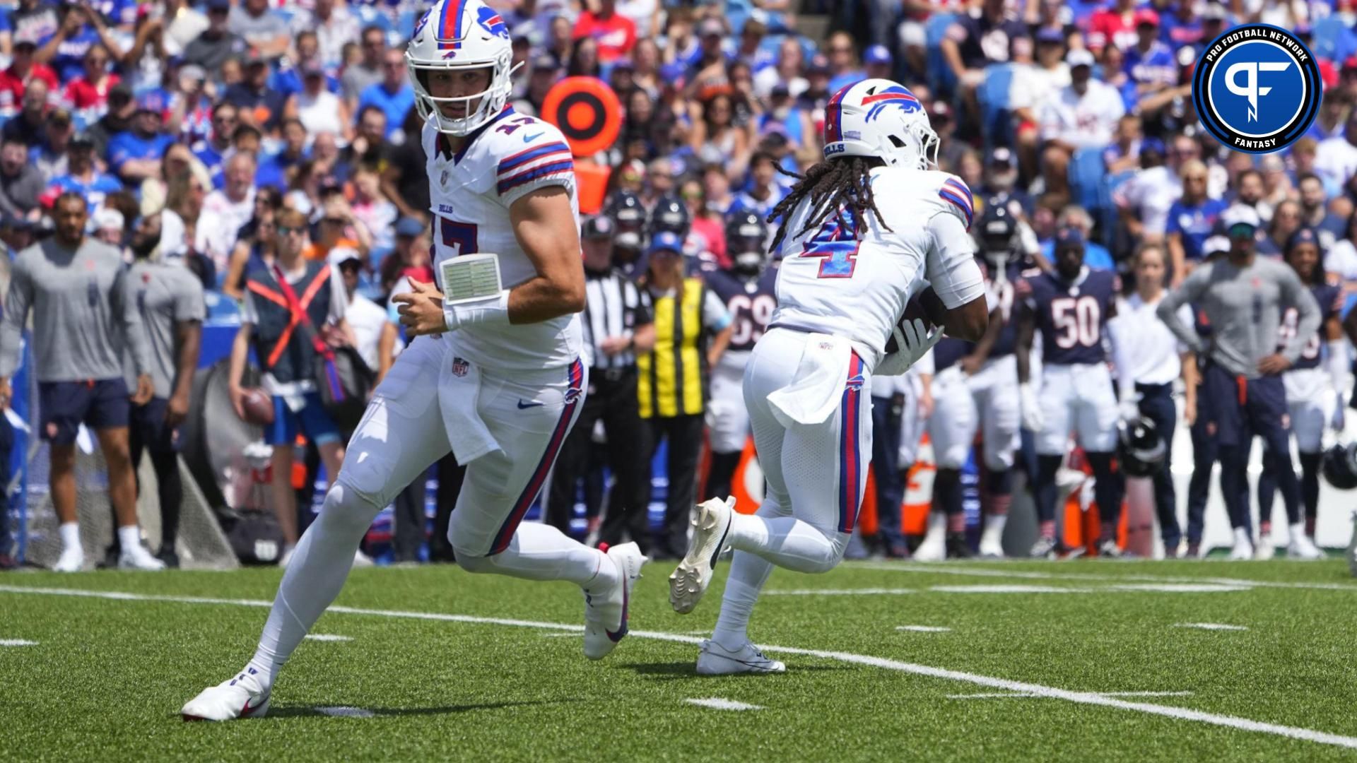 Buffalo Bills quarterback Josh Allen (17) hands the ball off to Buffalo Bills running back James Cook (4) against the Chicago Bears during the first half at Highmark Stadium.