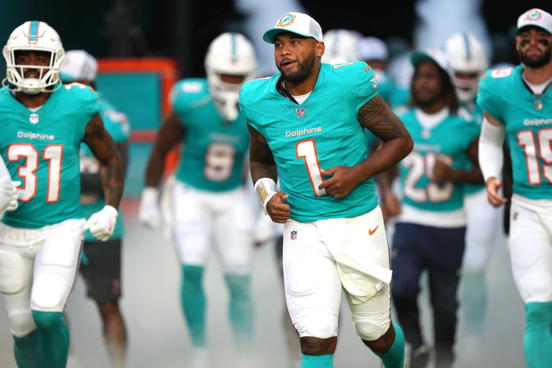 Miami Dolphins quarterback Tua Tagovailoa (1) takes to the field before the game against the Washington Commanders at Hard Rock Stadium.