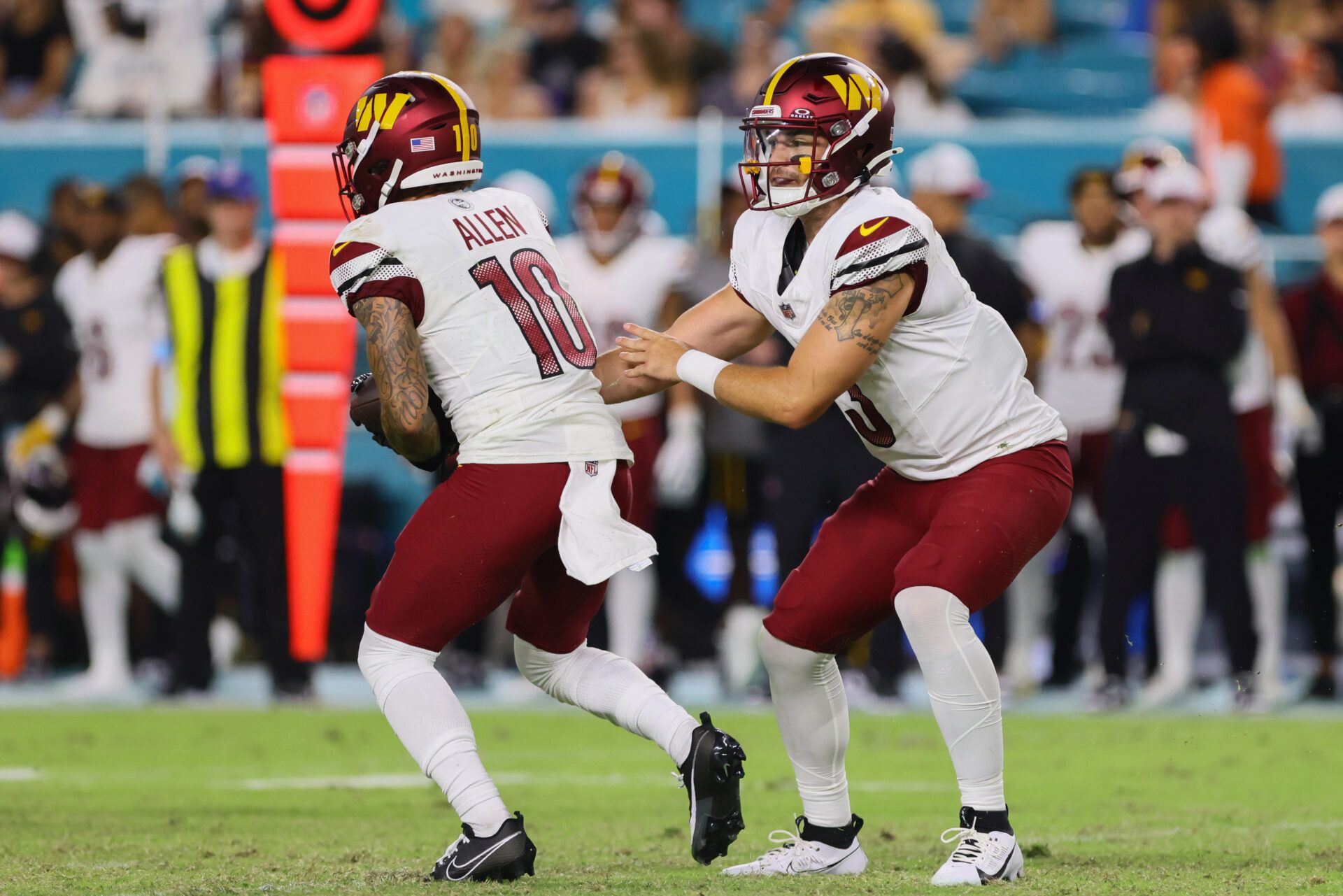 Aug 17, 2024; Miami Gardens, Florida, USA; Washington Commanders wide receiver Kazmeir Allen (10) takes a handoff from quarterback Trace McSorley (3) against the Miami Dolphins during the fourth quarter of a preseason game at Hard Rock Stadium. Mandatory Credit: Sam Navarro-USA TODAY Sports