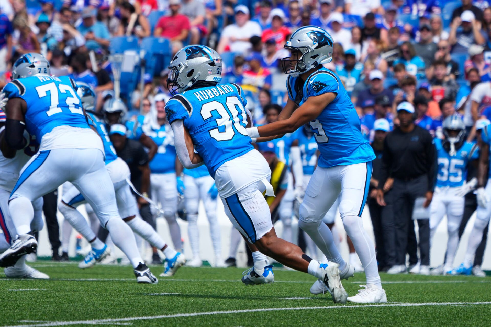 Aug 24, 2024; Orchard Park, New York, USA; Carolina Panthers quarterback Bryce Young (9) hands the ball off to Carolina Panthers running back Chuba Hubbard (30) against the Buffalo Bills during the first half at Highmark Stadium. Mandatory Credit: Gregory Fisher-USA TODAY Sports