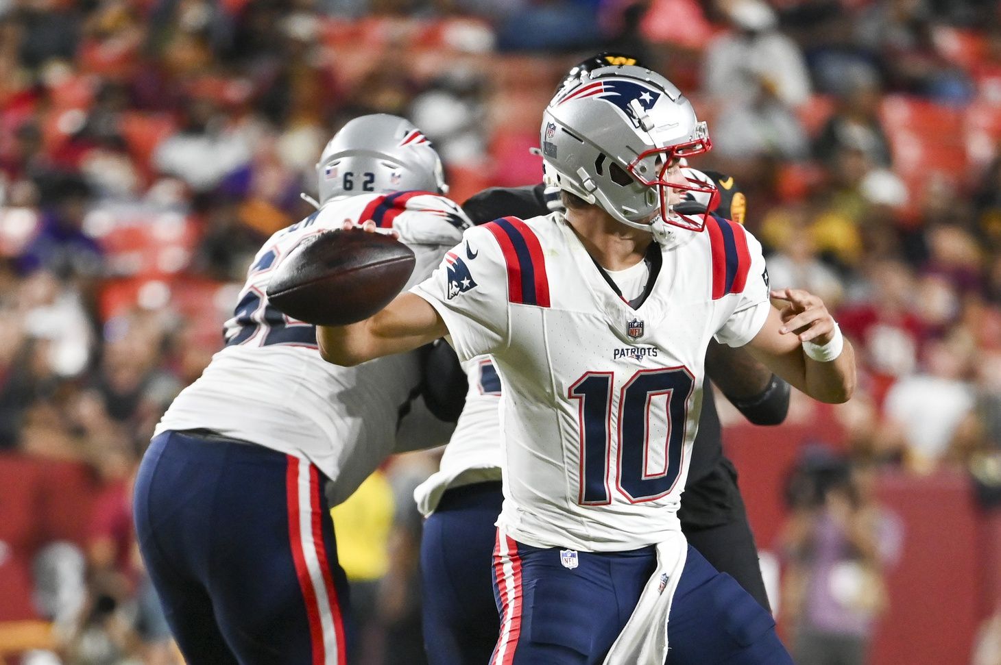 New England Patriots quarterback Drake Maye (10) throws during the first half against the Washington Commanders at Commanders Field.