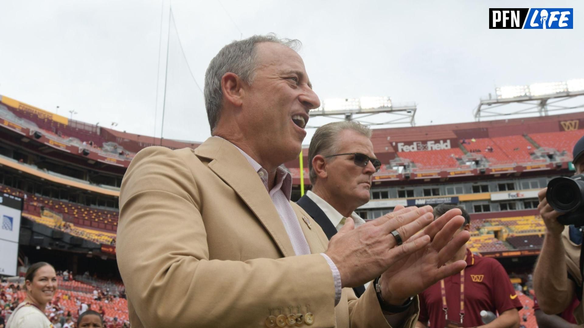 Washington Commanders managing partner Josh Harris claps his hands while walking down the field before the game against the Arizona Cardinals at FedExField. Josh Harris house