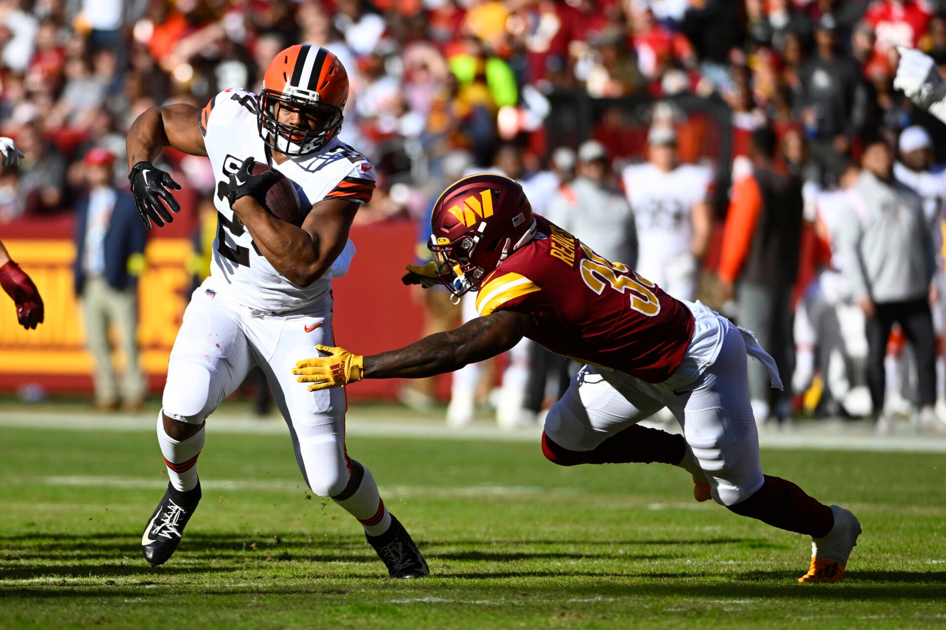 Jan 1, 2023; Landover, Maryland, USA; Cleveland Browns running back Nick Chubb (24) carries the ball as Washington Commanders safety Jeremy Reaves (39) defends during the first half at FedExField. Mandatory Credit: Brad Mills-USA TODAY Sports