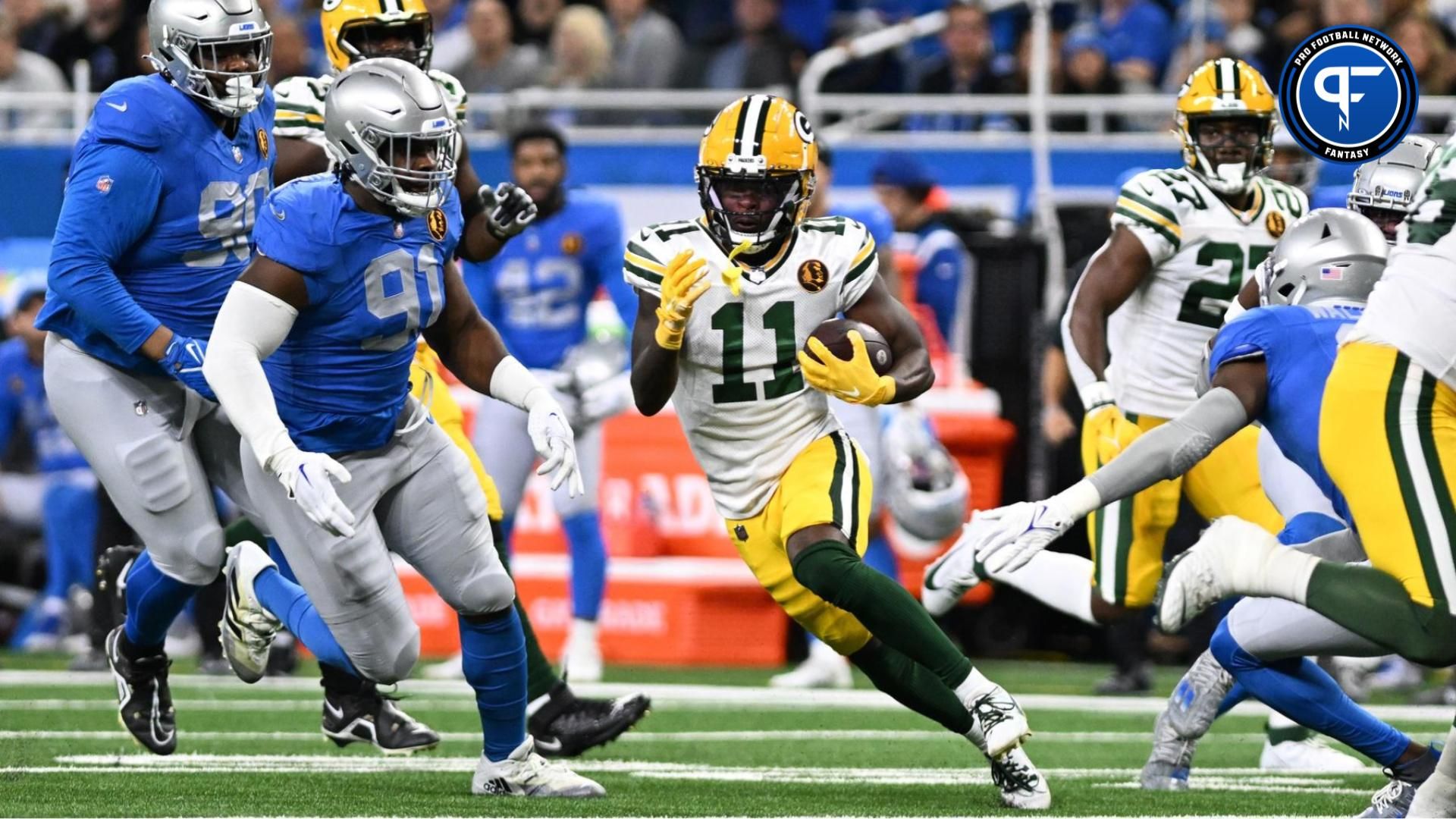 Green Bay Packers wide receiver Jayden Reed (11) runs the ball against the Detroit Lions in the first quarter at Ford Field. Mandatory Credit: Lon Horwedel-USA TODAY Sports