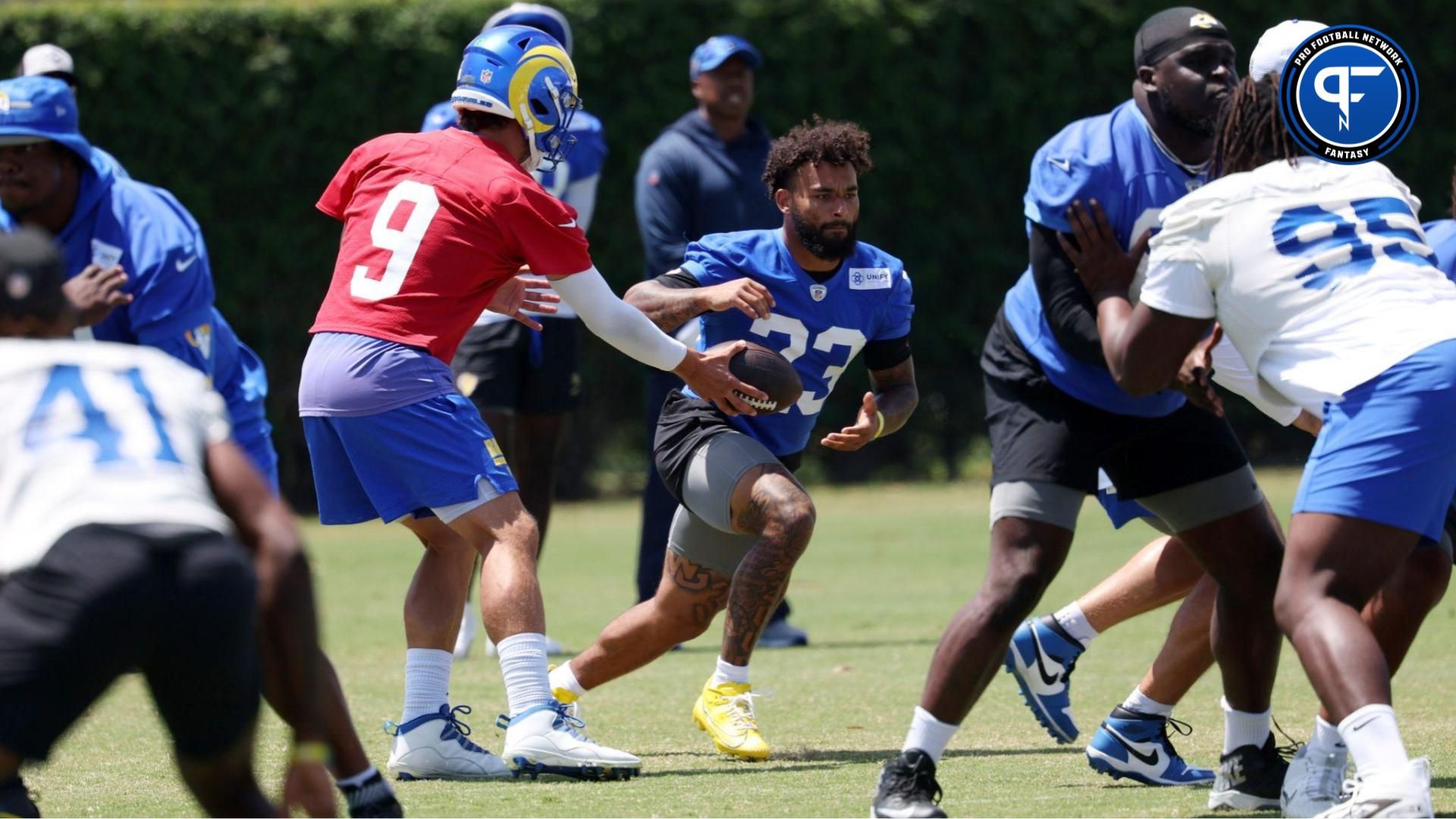 Los Angeles Rams quarterback Matthew Stafford (9) hands a ball off to running back Kyren Williams (23) in jog through during training camp at Loyola Marymount University. Is Kyren Williams' fantasy outlook better than Jonathan Taylor's?