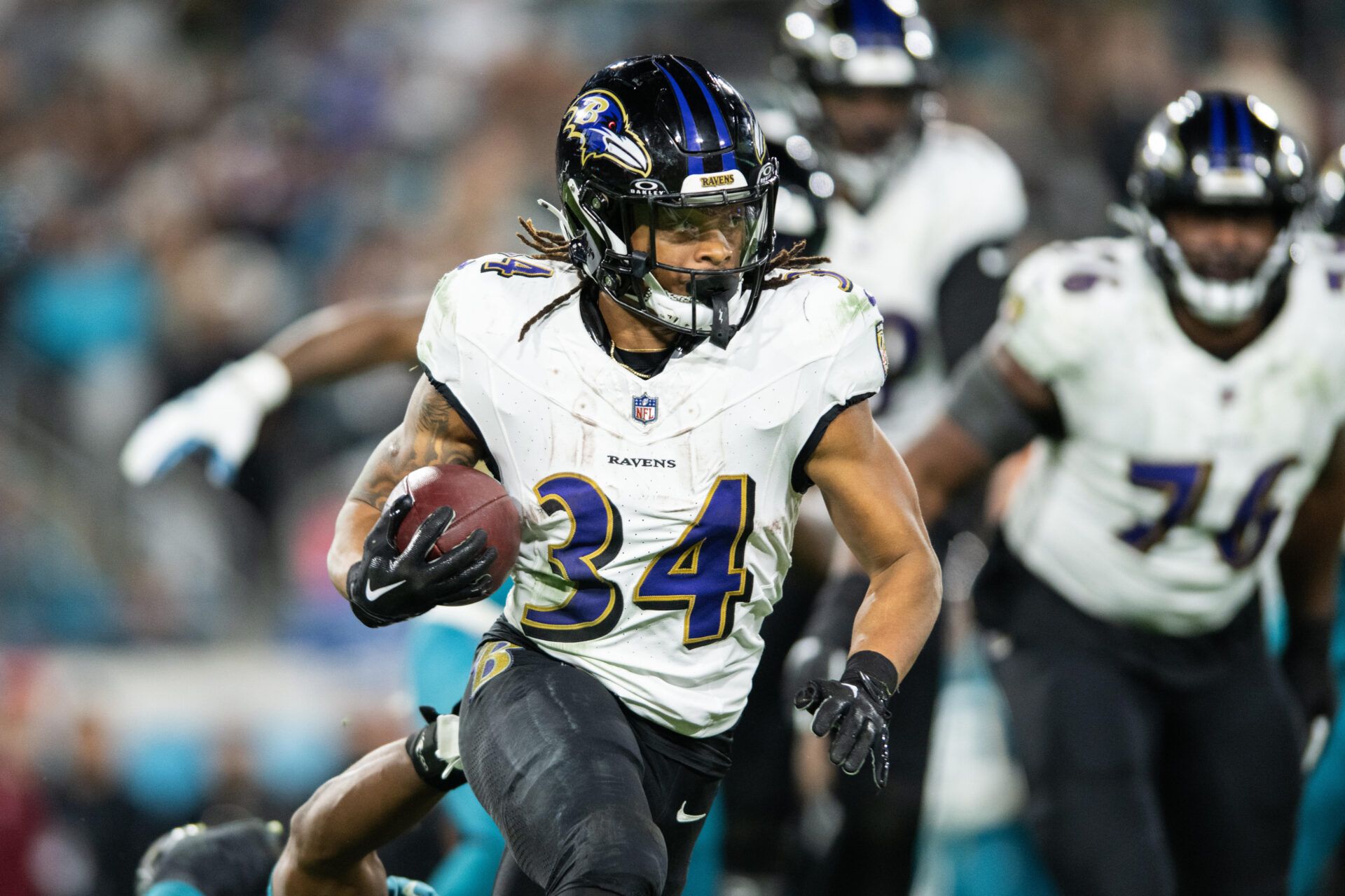 Dec 17, 2023; Jacksonville, Florida, USA; Baltimore Ravens running back Keaton Mitchell (34) runs the ball against the Jacksonville Jaguars in the fourth quarter at EverBank Stadium. Mandatory Credit: Jeremy Reper-USA TODAY Sports