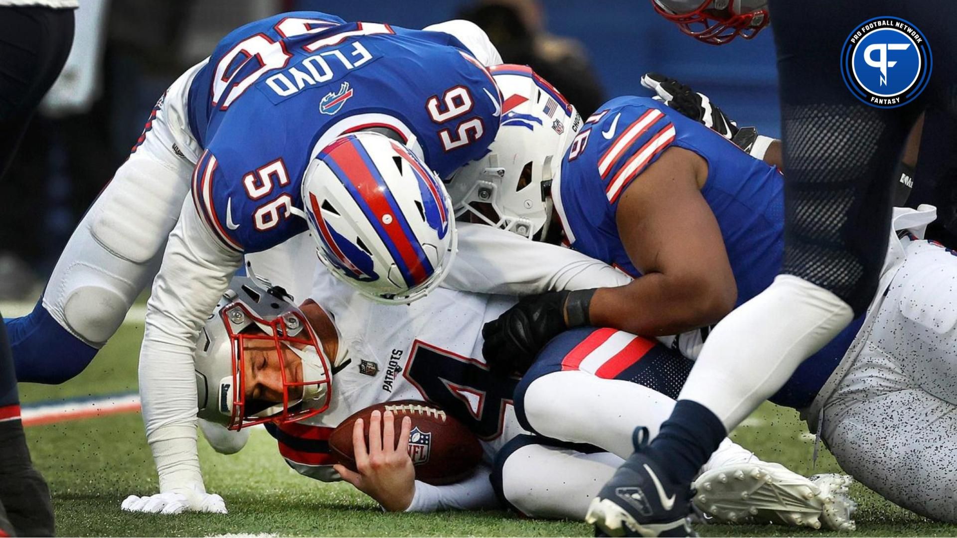 New England Patriots quarterback Bailey Zappe (4) is sacked by Buffalo Bills defensive end Leonard Floyd (56) and Buffalo Bills defensive tackle Ed Oliver (91). Zappe was pressure much of the game and sacked 3 times. Where do they land in our fantasy rankings?