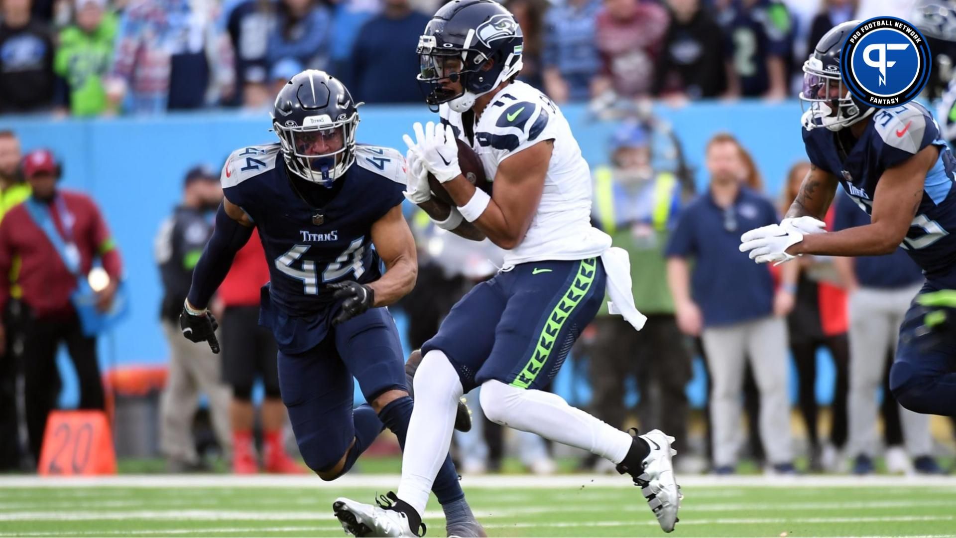 Seattle Seahawks wide receiver Jaxon Smith-Njigba (11) catches a pass for a first down before being tackled by Tennessee Titans safety Mike Brown (44) during the second half at Nissan Stadium. Should you draft Jaxon Smith-Njigba or Keon Coleman in fantasy football?