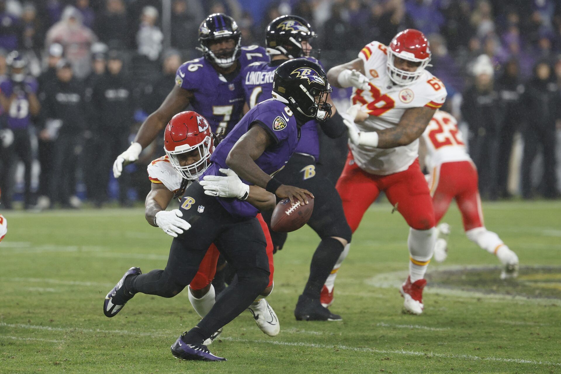 Baltimore Ravens quarterback Lamar Jackson (8) is sacked by Kansas City Chiefs defensive end Mike Danna (51) during the second half in the AFC Championship football game at M&T Bank Stadium. Mandatory Credit: Geoff Burke-USA TODAY Sports