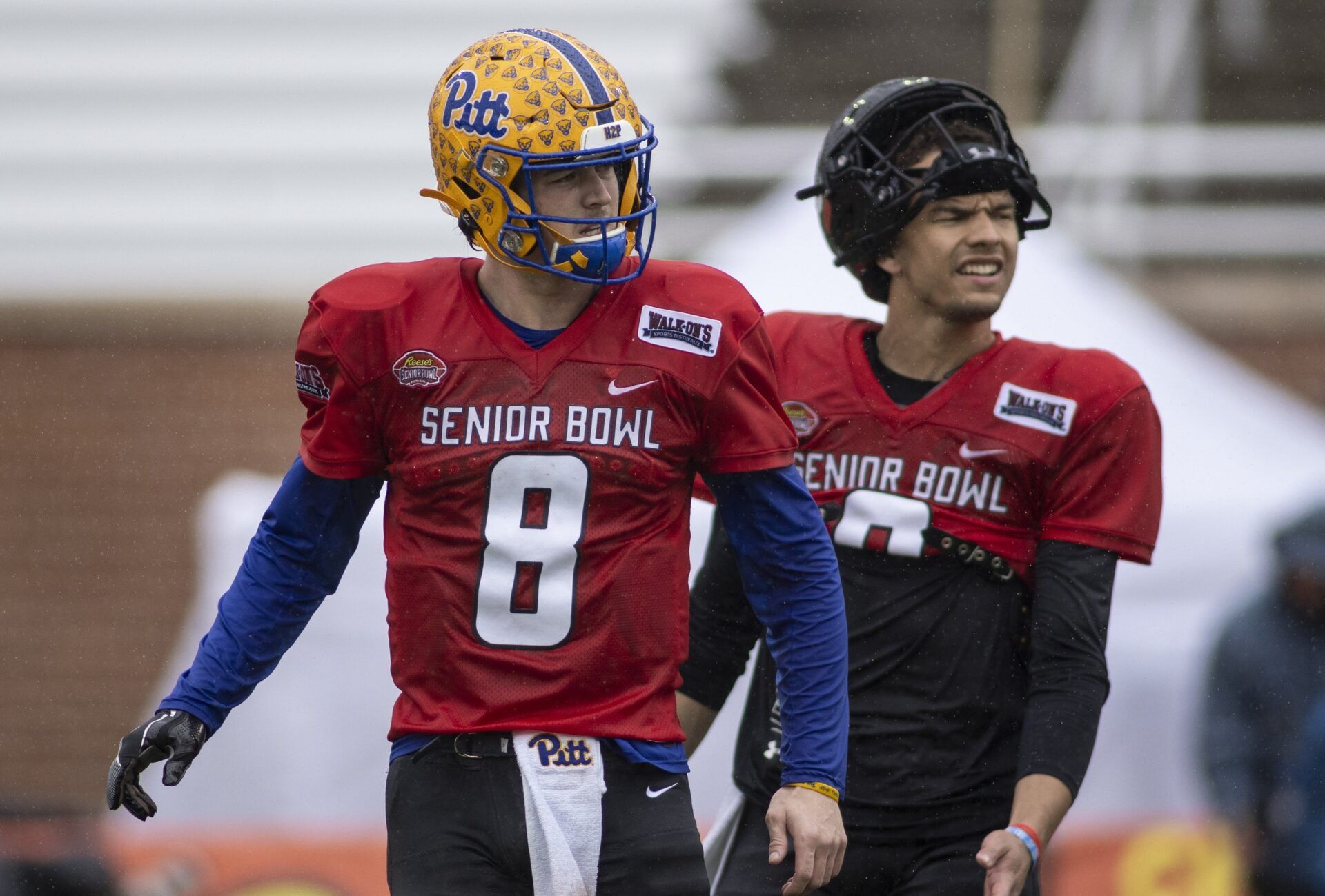 National quarterback Kenny Pickett of Pittsburgh (8) listens to coach during National practice for the 2022 Senior Bowl in Mobile, AL, USA. Mandatory Credit: Vasha Hunt-USA TODAY Sports ***National quarterback Desmond Ridder of Cincinnati (9) is seen in background***