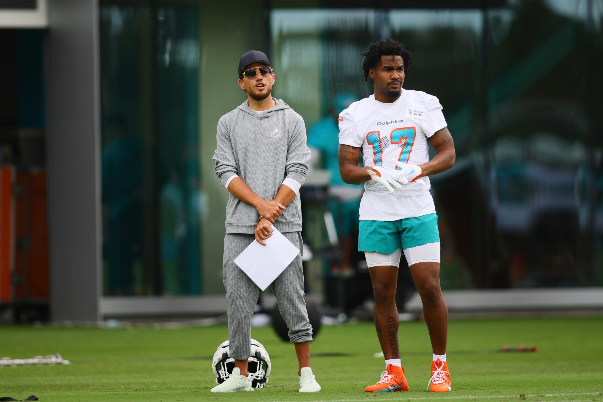 Jul 24, 2024; Miami Gardens, FL, USA; Miami Dolphins head coach Mike Mcdaniel and wide receiver Jaylen Waddle (17) look on during training camp at Baptist Health Training Complex. Mandatory Credit: Sam Navarro-USA TODAY Sports