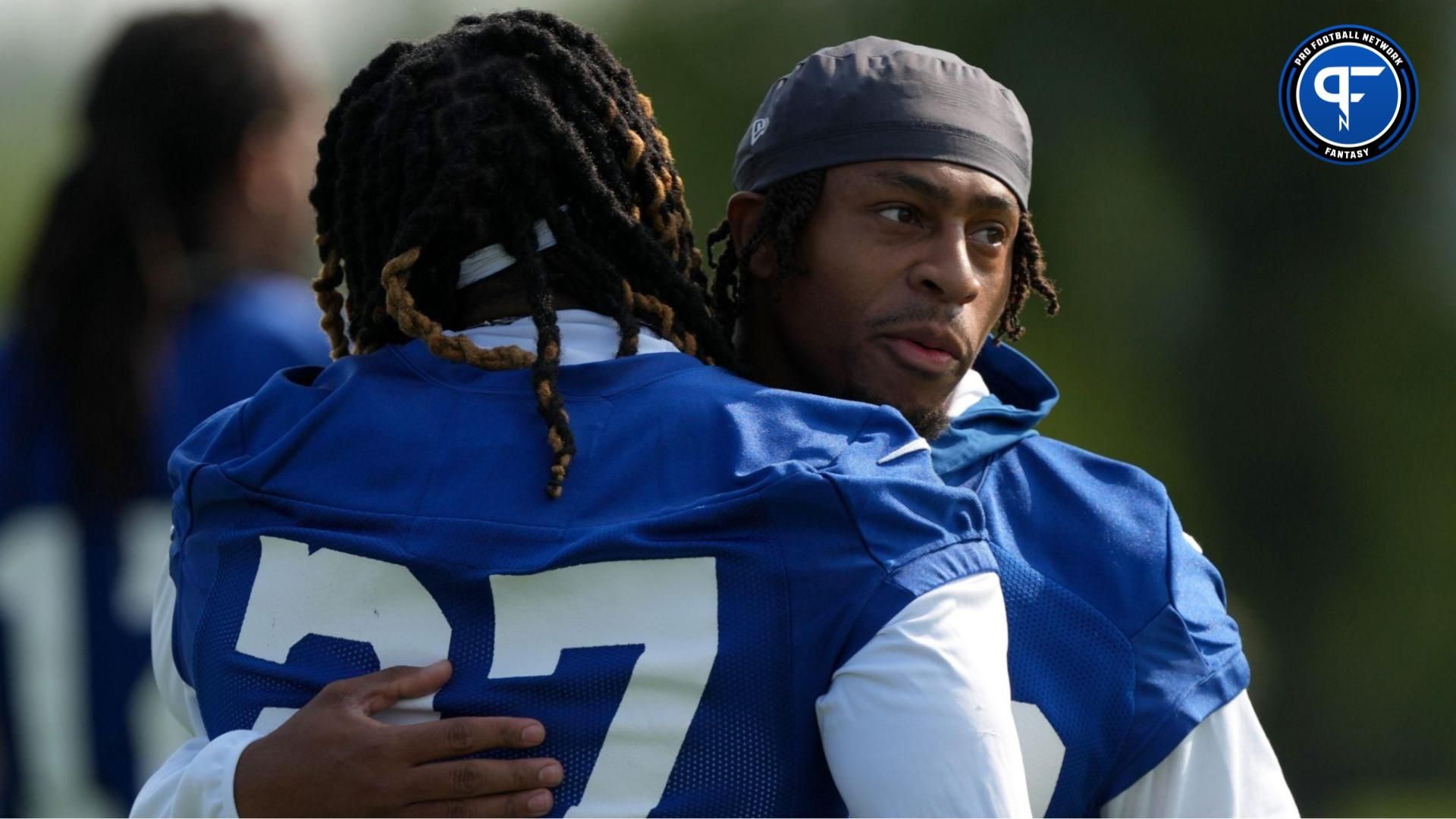 Indianapolis Colts running back Jonathan Taylor (28) hugs running back Trey Sermon (27) before practice begins during the first day of the Indianapolis Colts’ training camp Thursday, July 25, 2024, at Grand Park Sports Complex in Westfield. © Christine Tannous/IndyStar / USA TODAY NETWORK