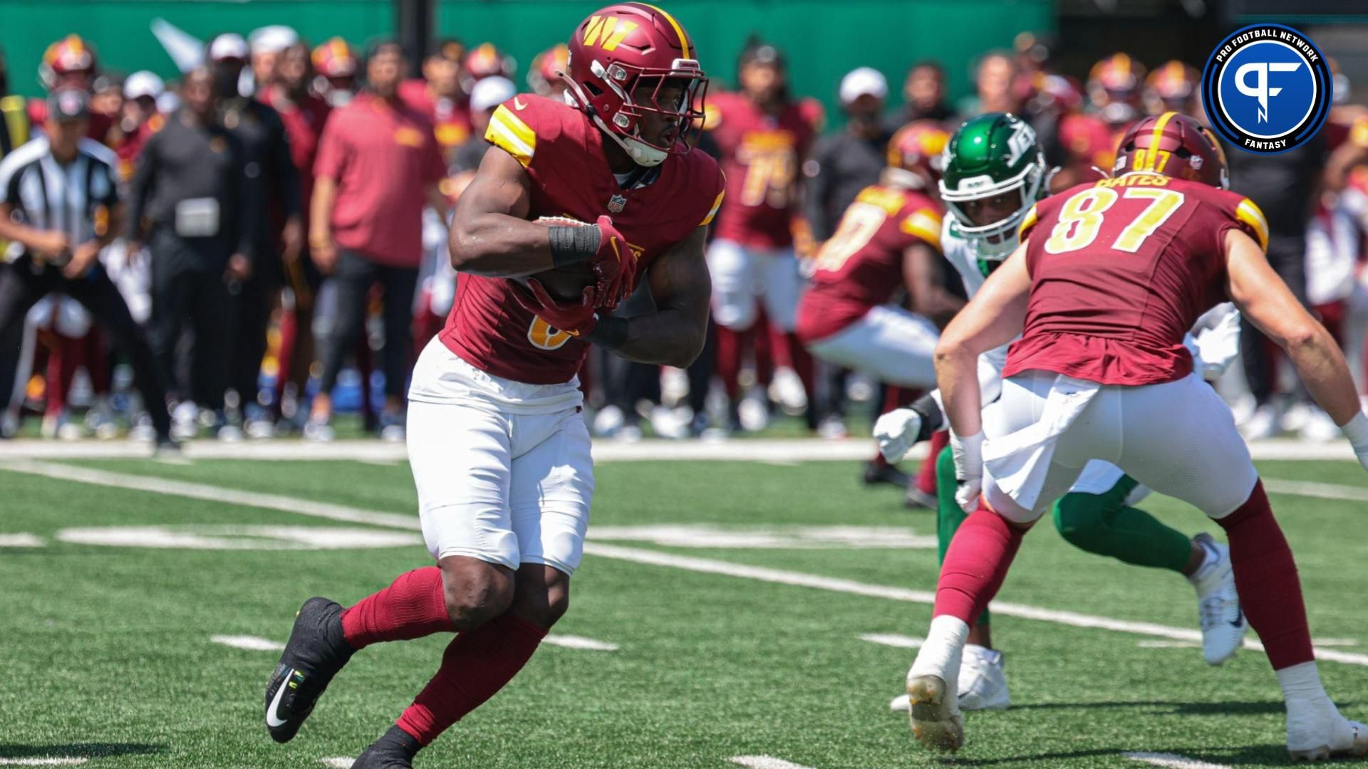 Washington Commanders running back Brian Robinson Jr. (8) carries the ball during the first quarter against the New York Jets at MetLife Stadium.