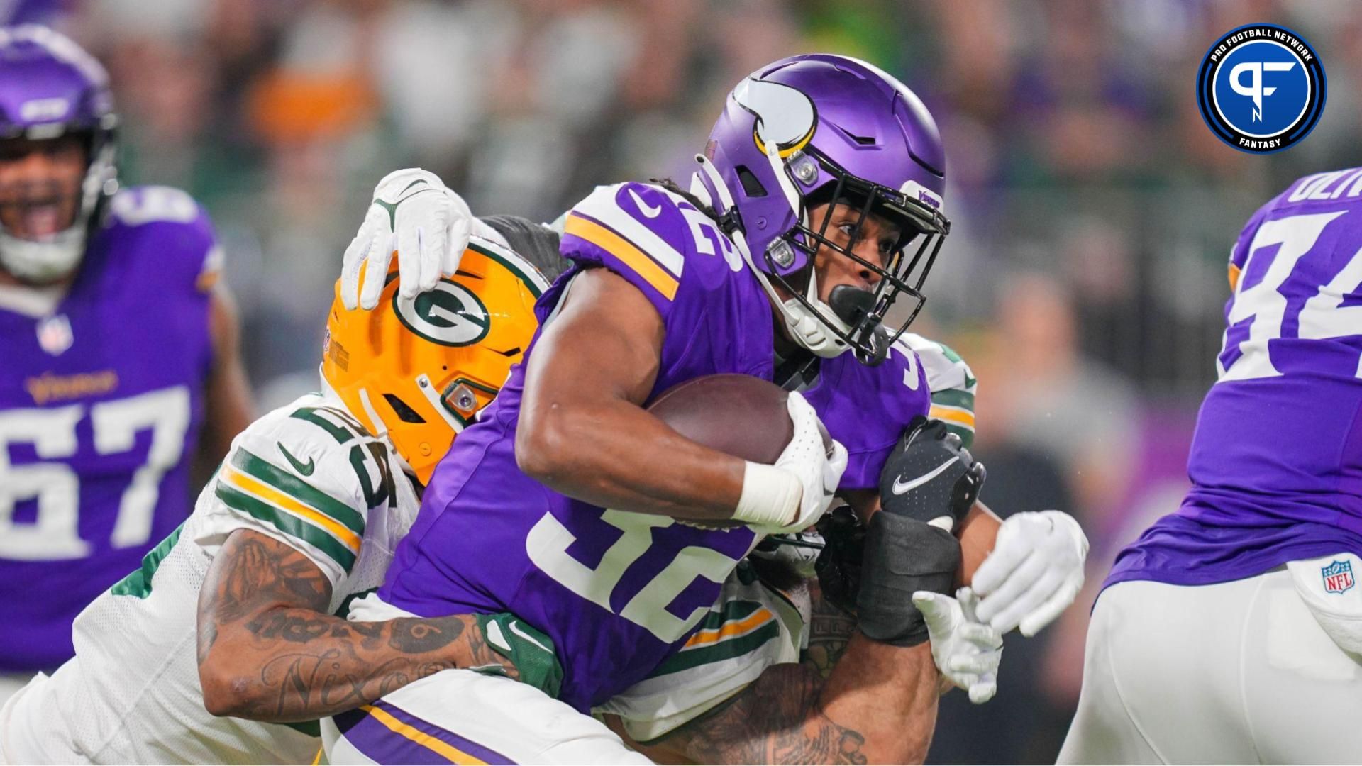 Dec 31, 2023; Minneapolis, Minnesota, USA; Minnesota Vikings running back Ty Chandler (32) runs with the ball against the Green Bay Packers in the first quarter at U.S. Bank Stadium. Mandatory Credit: Brad Rempel-USA TODAY Sports