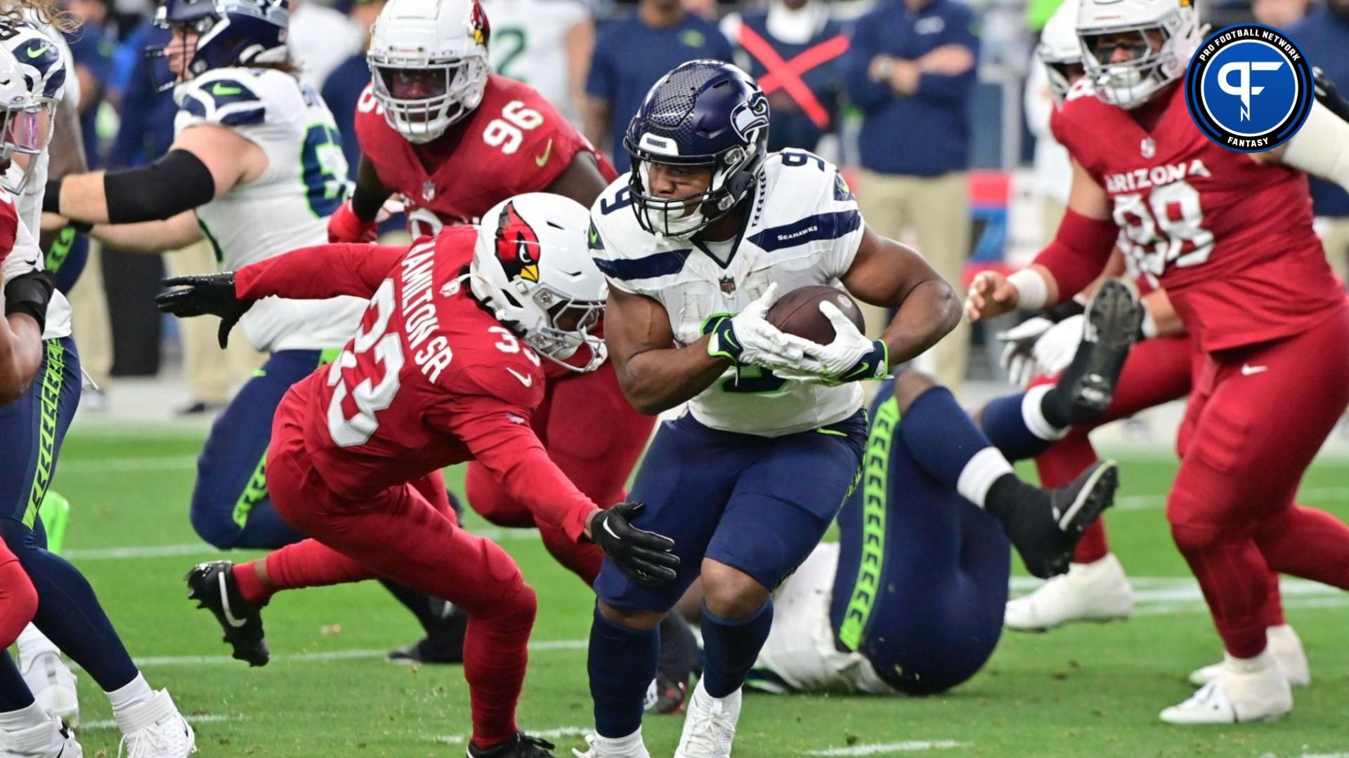 Seattle Seahawks running back Kenneth Walker III (9) runs the ball as Arizona Cardinals cornerback Antonio Hamilton Sr. (33) defends in the first half at State Farm Stadium.