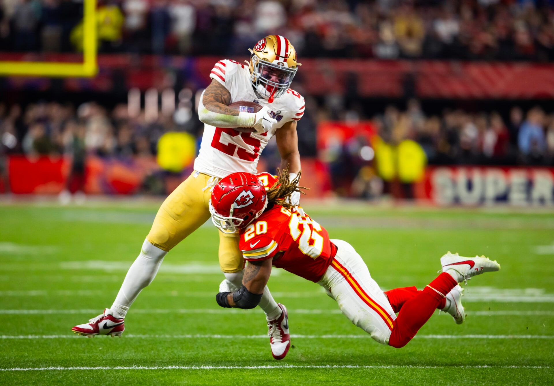 Feb 11, 2024; Paradise, Nevada, USA; San Francisco 49ers running back Elijah Mitchell (25) is tackled by Kansas City Chiefs safety Justin Reid (20) in Super Bowl LVIII at Allegiant Stadium. Mandatory Credit: Mark J. Rebilas-USA TODAY Sports