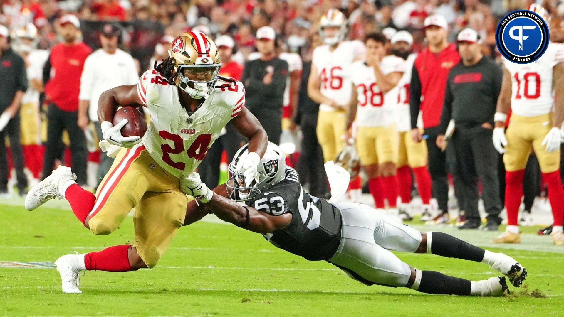 Aug 23, 2024; Paradise, Nevada, USA; San Francisco 49ers running back Jordan Mason (24) attempts to break the tackle of Las Vegas Raiders linebacker Amari Gainer (53) during the second quarter at Allegiant Stadium. Mandatory Credit: Stephen R. Sylvanie-USA TODAY Sports