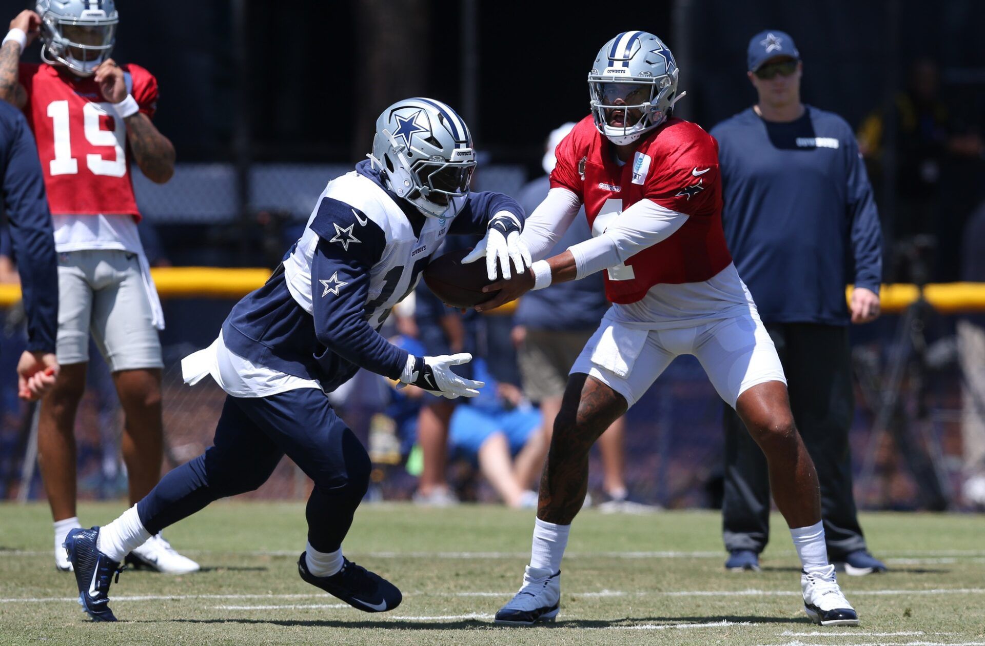 Dallas Cowboys quarterback Dak Prescott (4) hands off to running back Ezekiel Elliott (15) during training camp at the River Ridge Playing Fields in Oxnard, California. Mandatory Credit: Jason Parkhurst-USA TODAY Sports