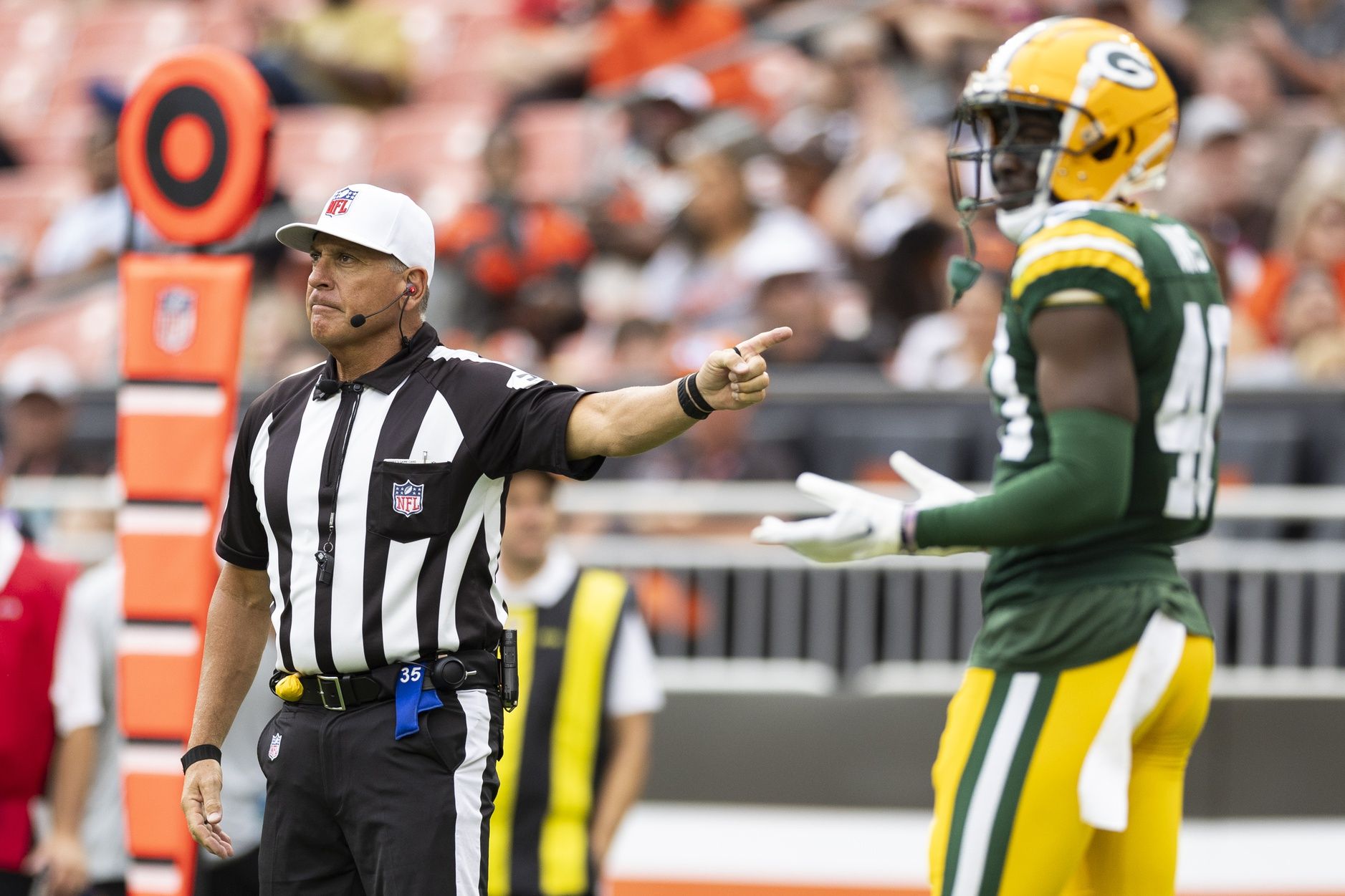 NFL referee John Hussey (35) calls a holding penalty on Green Bay Packers cornerback LJ Davis (40) during the fourth quarter against the Cleveland Browns at Cleveland Browns Stadium. Mandatory Credit: Scott Galvin-USA TODAY Sports