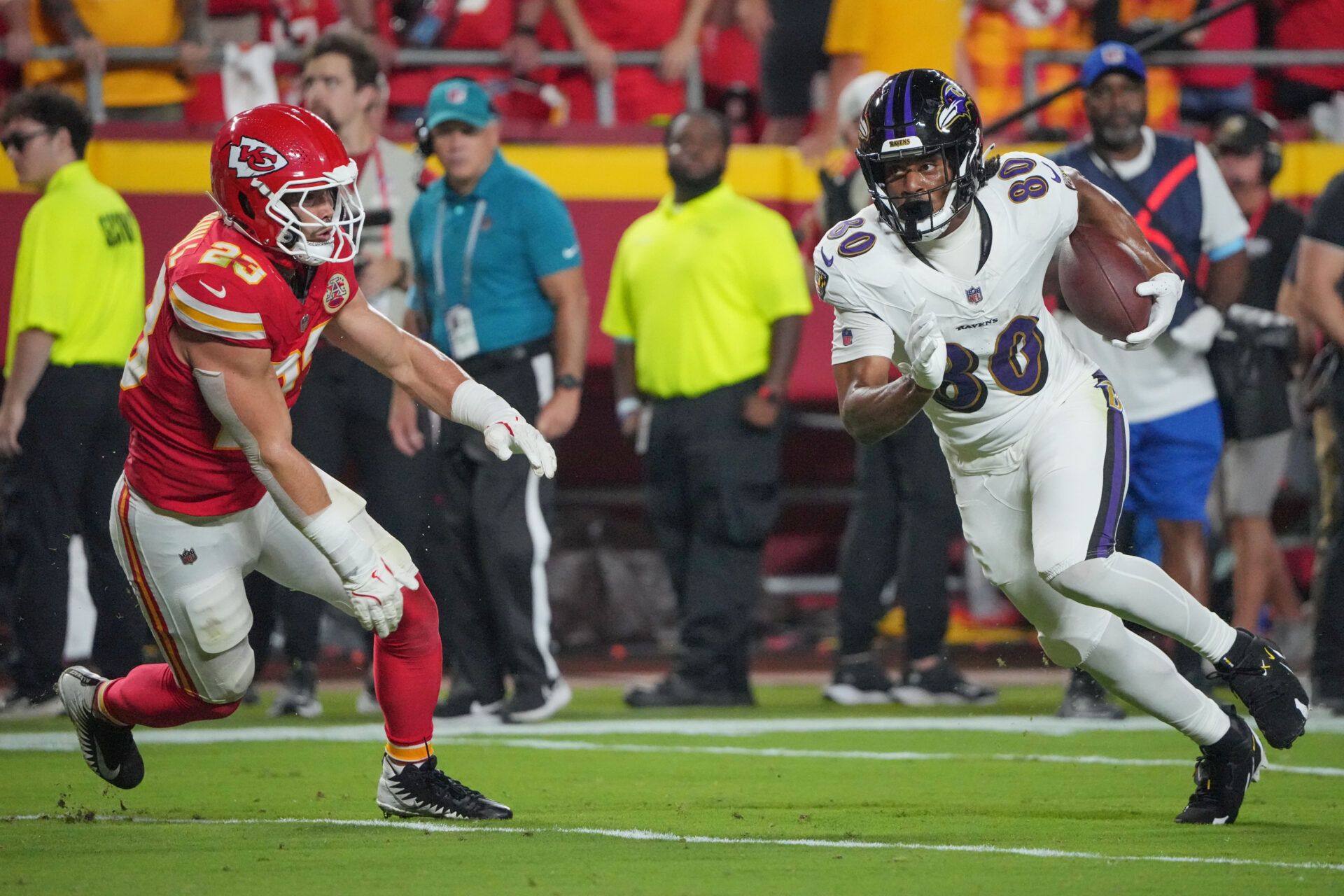 Sep 5, 2024; Kansas City, Missouri, USA; Baltimore Ravens tight end Isaiah Likely (80) runs the ball as Kansas City Chiefs linebacker Drue Tranquill (23) defends during the first half at GEHA Field at Arrowhead Stadium. Mandatory Credit: Denny Medley-Imagn Images