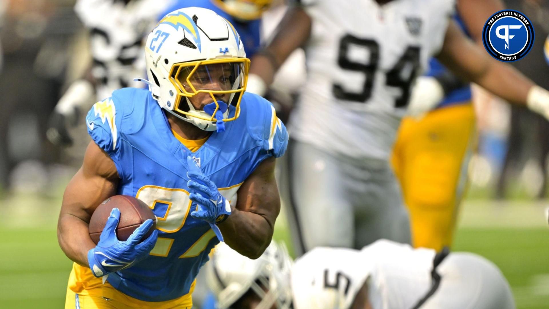 Los Angeles Chargers running back J.K. Dobbins (27) breaks away from Las Vegas Raiders linebacker Divine Deablo (5) and runs for a touchdown in the second half at SoFi Stadium. Mandatory Credit: Jayne Kamin-Oncea-Imagn Images