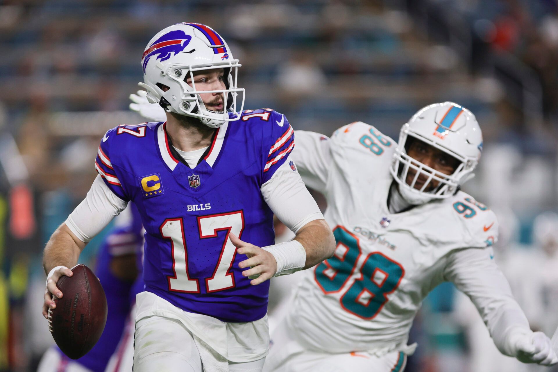 Jan 7, 2024; Miami Gardens, Florida, USA; Buffalo Bills quarterback Josh Allen (17) runs with the football against the Miami Dolphins during the second quarter at Hard Rock Stadium. Mandatory Credit: Sam Navarro-USA TODAY Sports