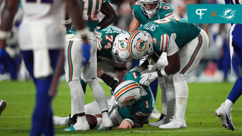 Miami Dolphins offensive tackle Liam Eichenberg (74) and tight end Jonnu Smith (9) attend to quarterback Tua Tagovailoa (1) after an apparent injury during the second half against the Buffalo Bills at Hard Rock Stadium. Mandatory Credit: Jasen Vinlove-Imagn