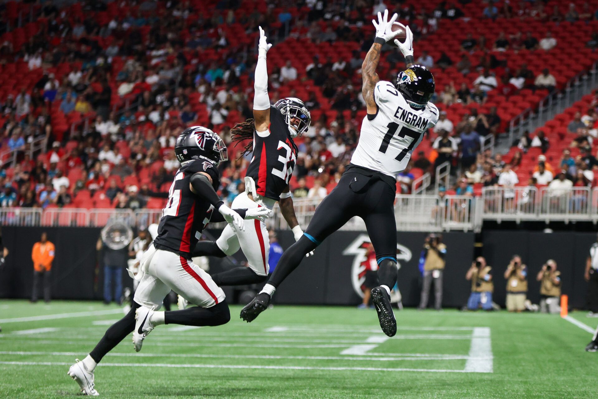 Aug 23, 2024; Atlanta, Georgia, USA; Jacksonville Jaguars tight end Evan Engram (17) catches a touchdown pass over Atlanta Falcons cornerback Jayden Price (36) and cornerback Kevin King (32) in the first quarter at Mercedes-Benz Stadium. Mandatory Credit: Brett Davis-USA TODAY Sports