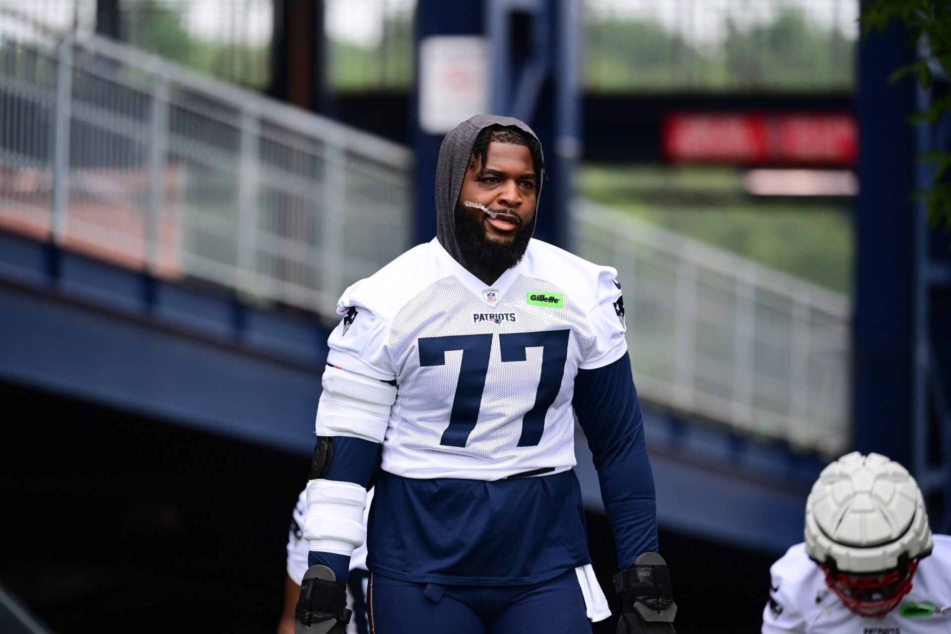 New England Patriots offensive tackle Chukwuma Okorafor (77) walks to the practice field during training camp at Gillette Stadium. Mandatory Credit: Eric Canha-USA TODAY Sports