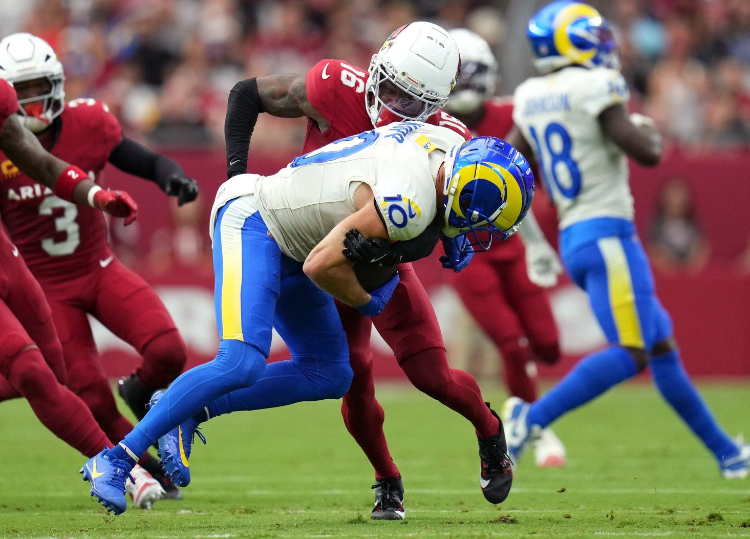 Arizona Cardinals cornerback Max Melton (16) tackles Los Angeles Rams receiver Cooper Kupp (10) on Sept. 15, 2024, at State Farm Stadium in Glendale.